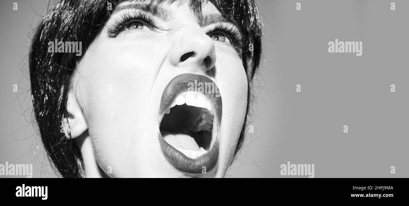 Crazy woman screaming and shouting. Shout and scream mouth. Close up screaming face. Stock Photo