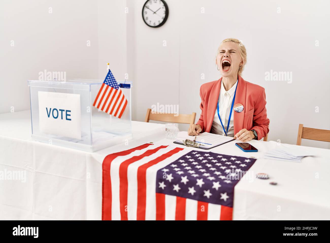 Beautiful caucasian woman working at political campaign angry and mad ...