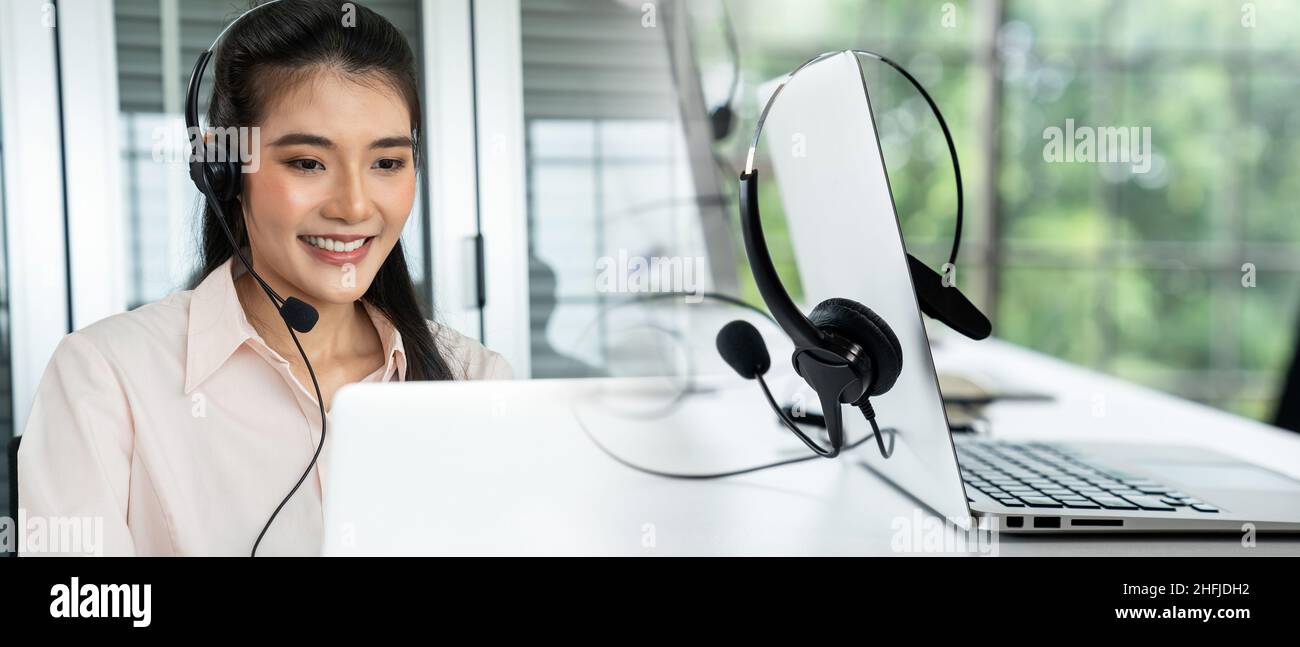 Businesswoman wearing headset working actively in office . Call center,  telemarketing, customer support agent provide service on telephone video  Stock Photo - Alamy