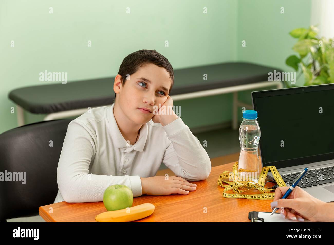Boy at a nutritionist appointment. Childhood obesity problem. Stock Photo