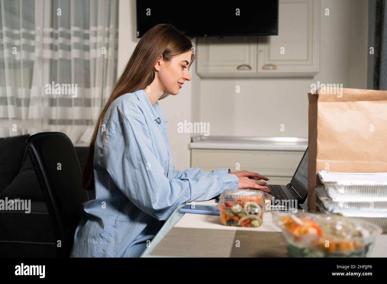 Home food delivery concept. Woman at the table with disposable