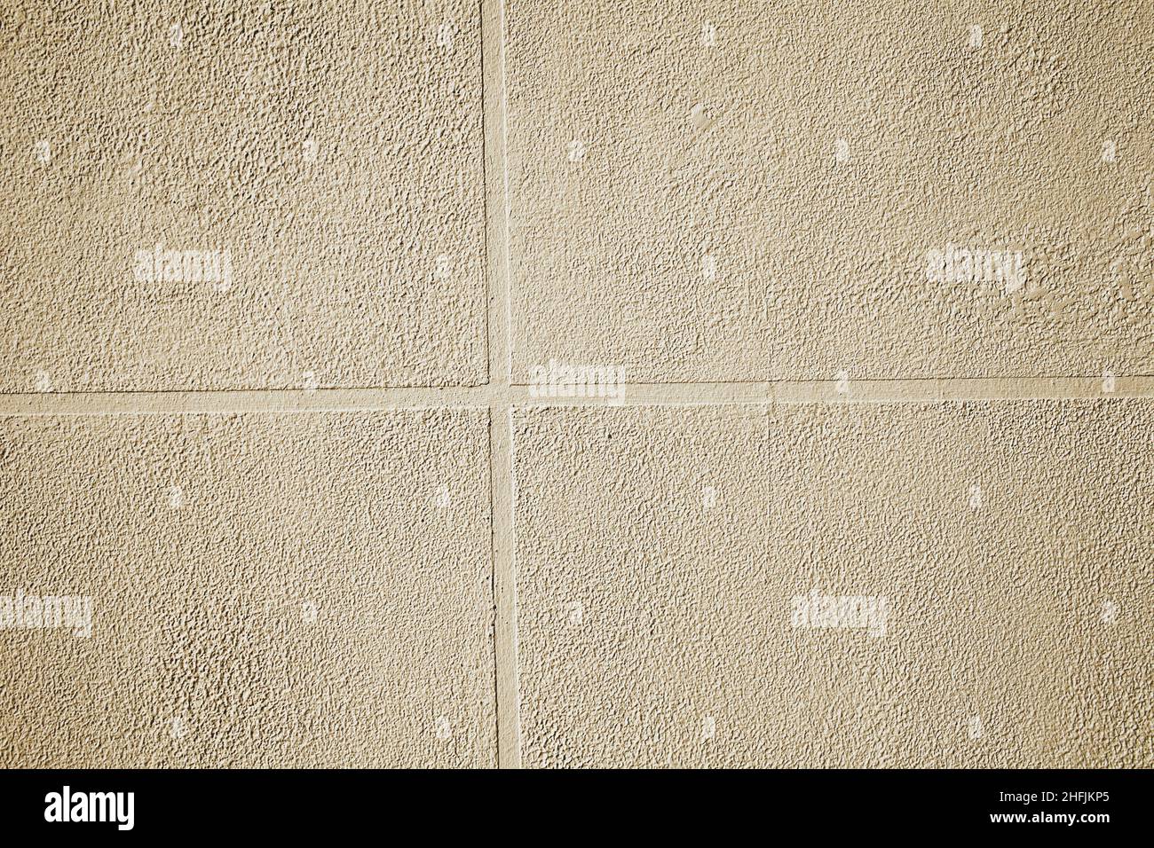 External finishing of concrete wall imitating ceramic tile, textured background. Stock Photo