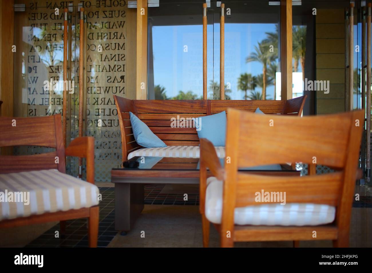 Street restaurant with dinner furnishing and reflection of palm trees