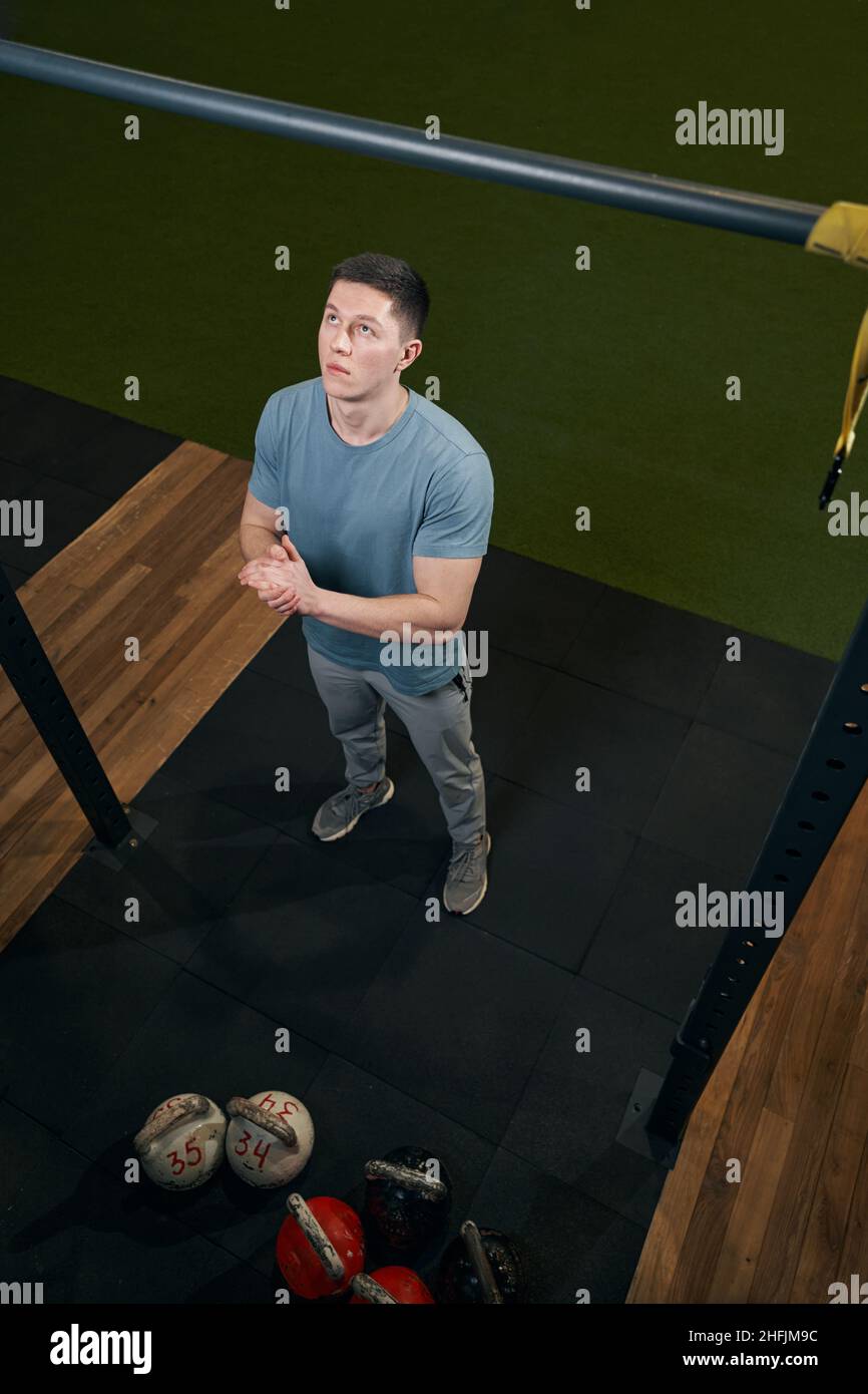 Focused young Caucasian man preparing for pull-ups Stock Photo