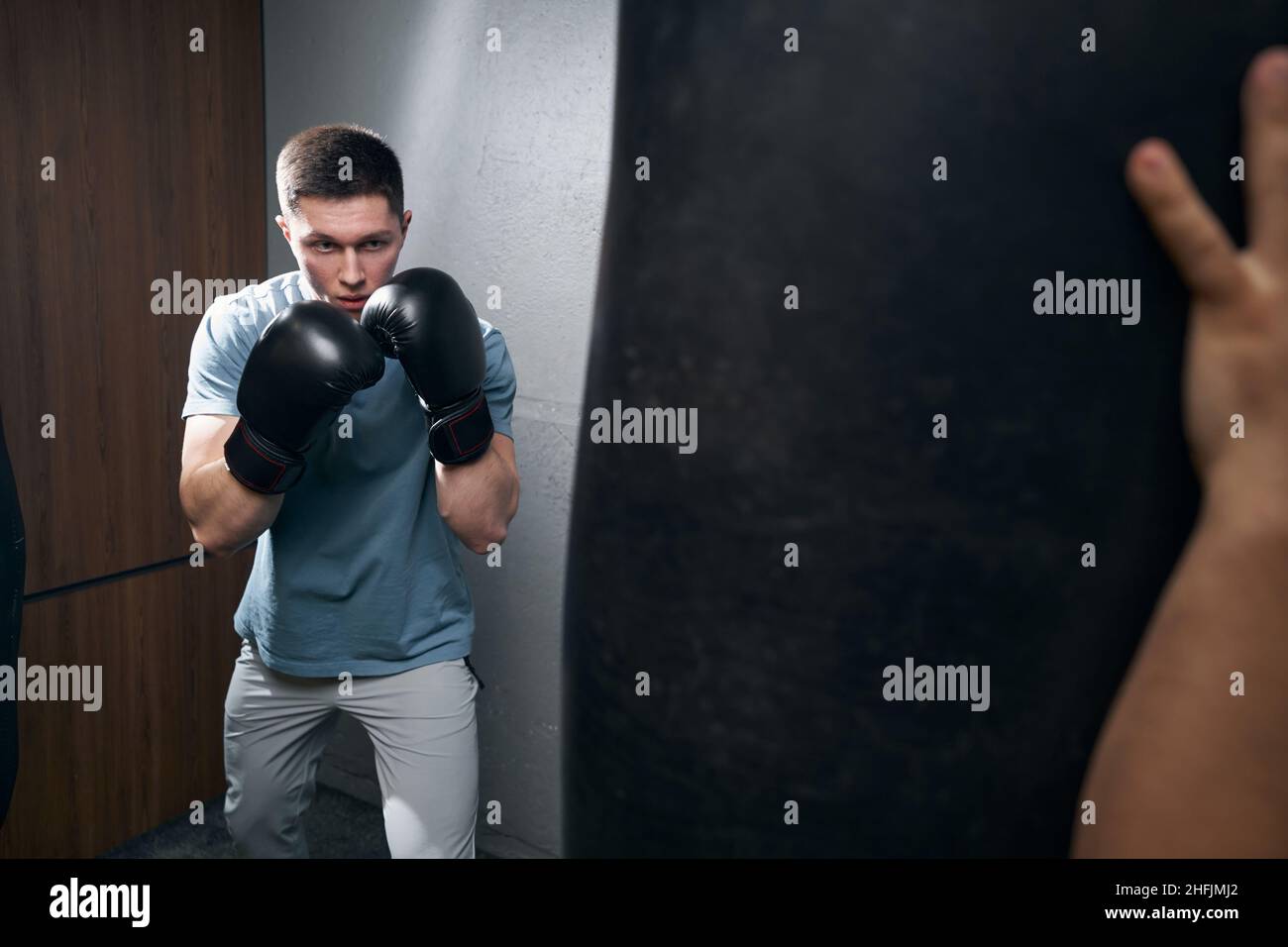 Serious focused Caucasian kickboxer preparing for workout Stock Photo