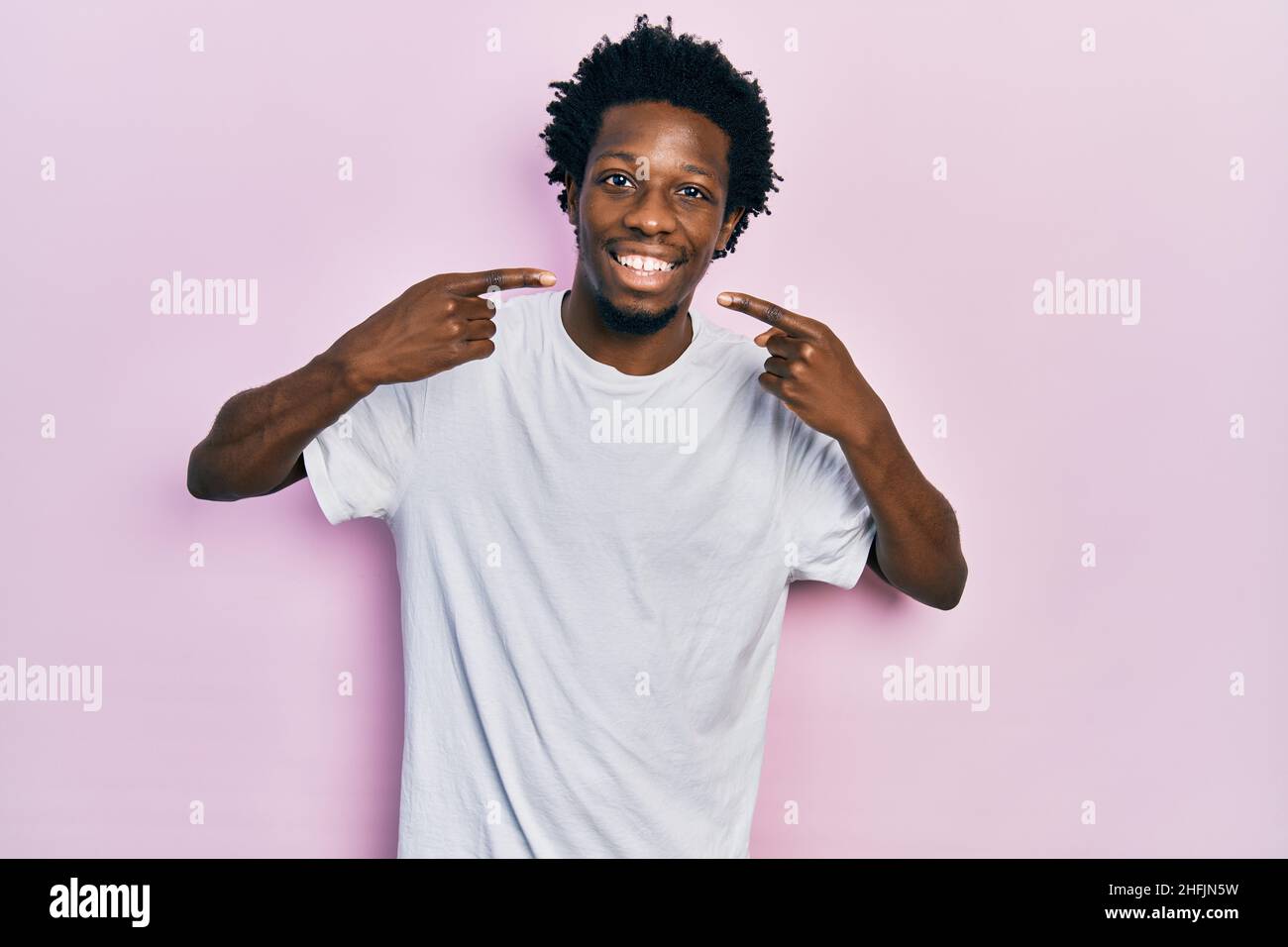 Young african american man wearing casual white t shirt smiling ...