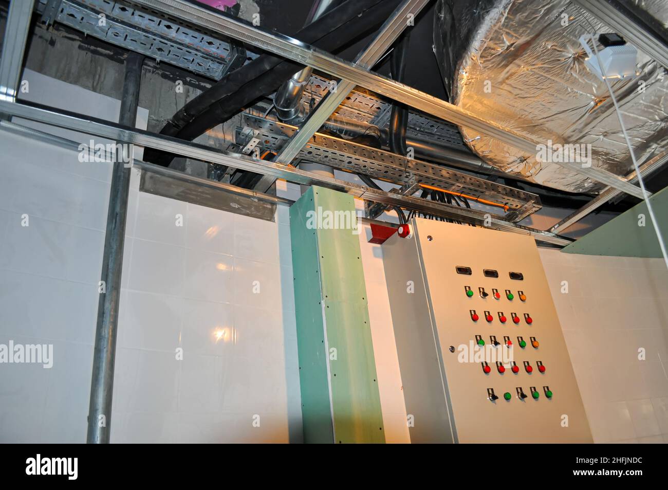 Installation of a false ceiling in a restaurant, with an air duct, wires and a control panel. Stock Photo