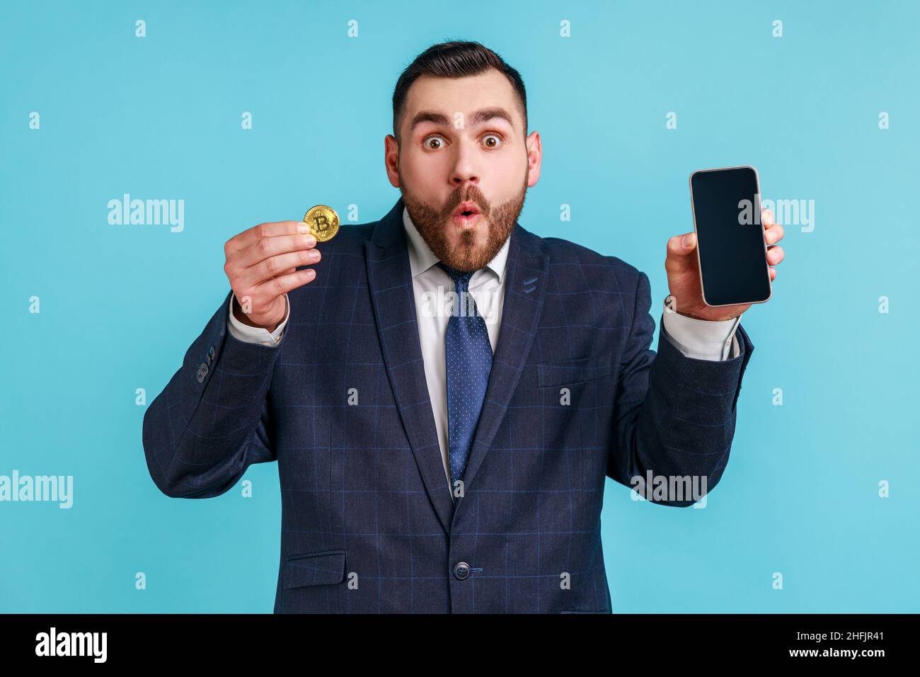 Shocked young man showing mobile hi-res stock photography and ...