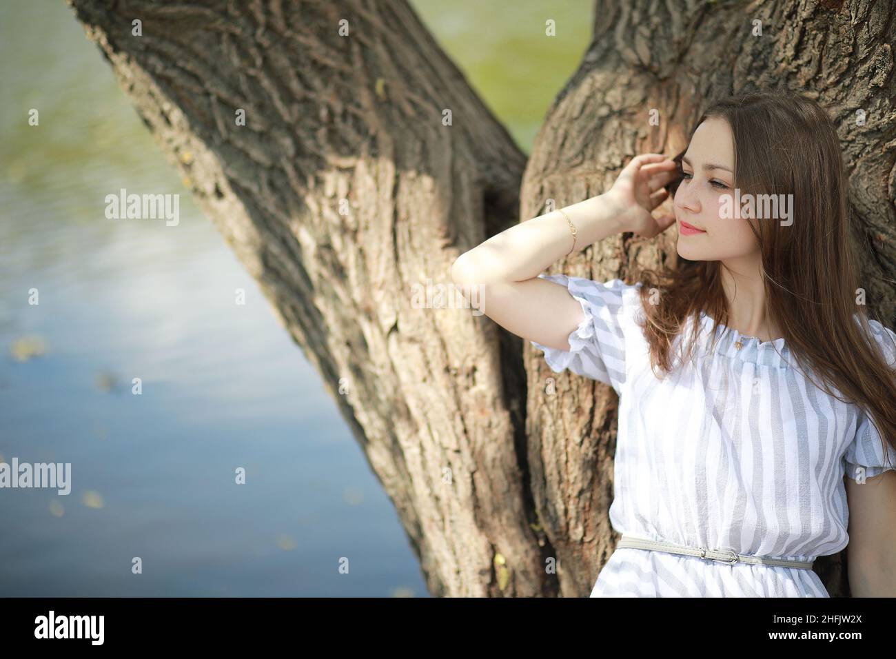 A girl in a spring green park on a walk Stock Photo - Alamy