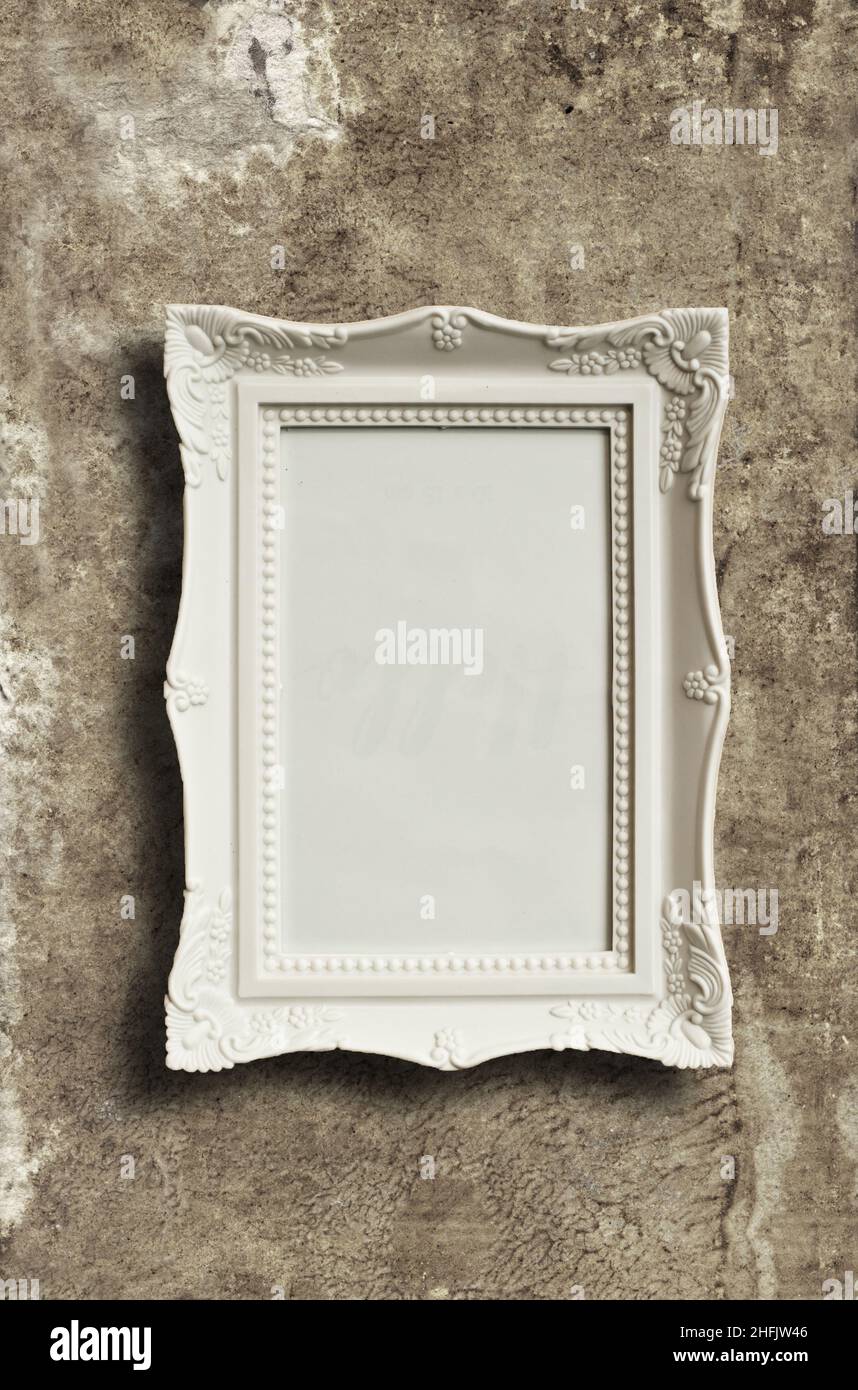 white blank picture frame on grunge wall Stock Photo