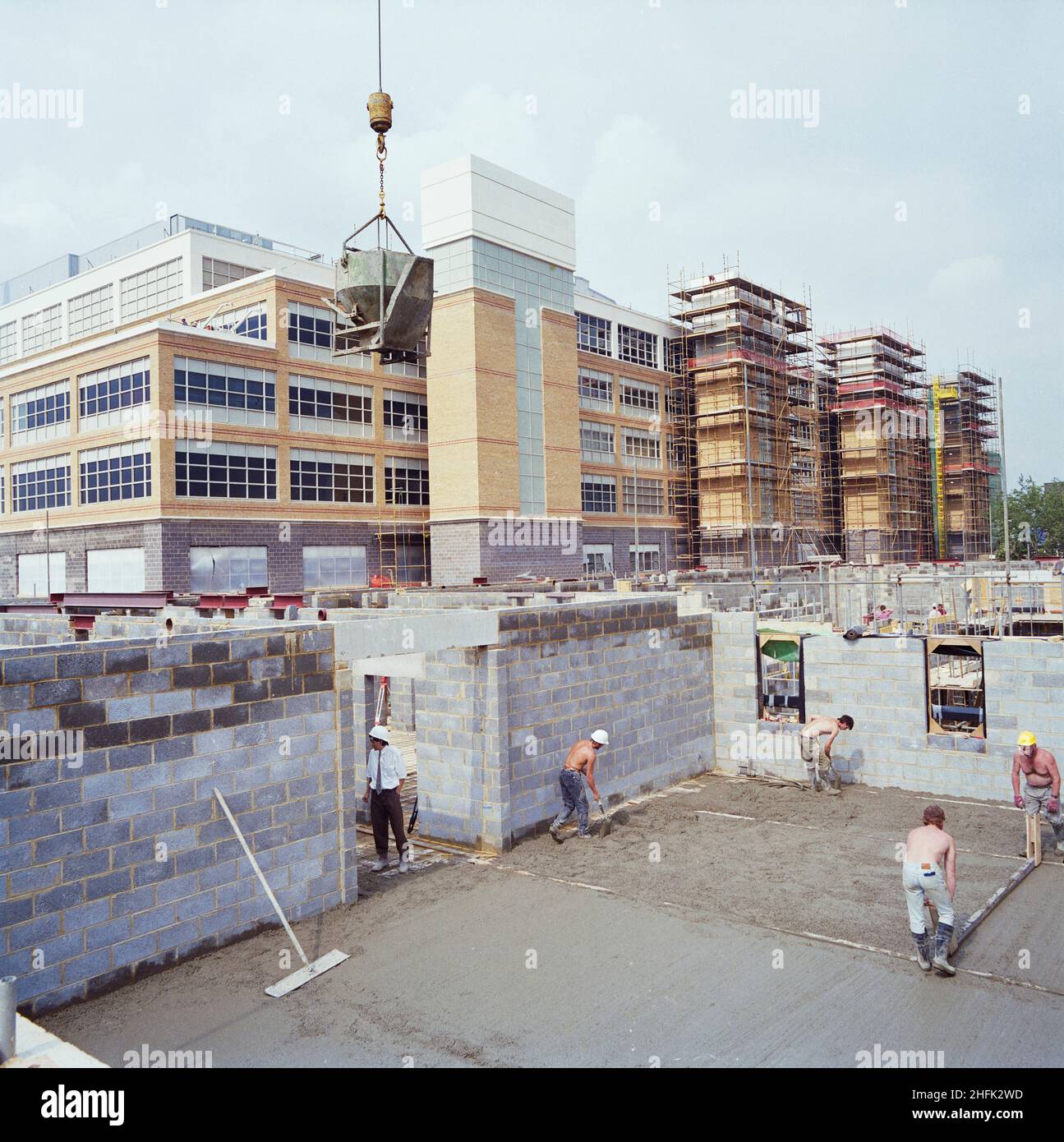 Chelsea and Westminster Hospital, Fulham Road, Kensington and Chelsea, London, 01/08/1991. A view from the south east showing Chelsea and Westminster Hospital during construction, with workers levelling concrete for the ground floor of the Mental Health Centre in the foreground. Laing Management Contracting worked on the construction of Chelsea and Westminster Hospital on behalf of the North West Thames Regional Health Authority between 1989 and 1993. The new teaching hospital was built on the site of the old St Stephen&#x2019;s Hospital, which was demolished in the early months of 1989. The u Stock Photo