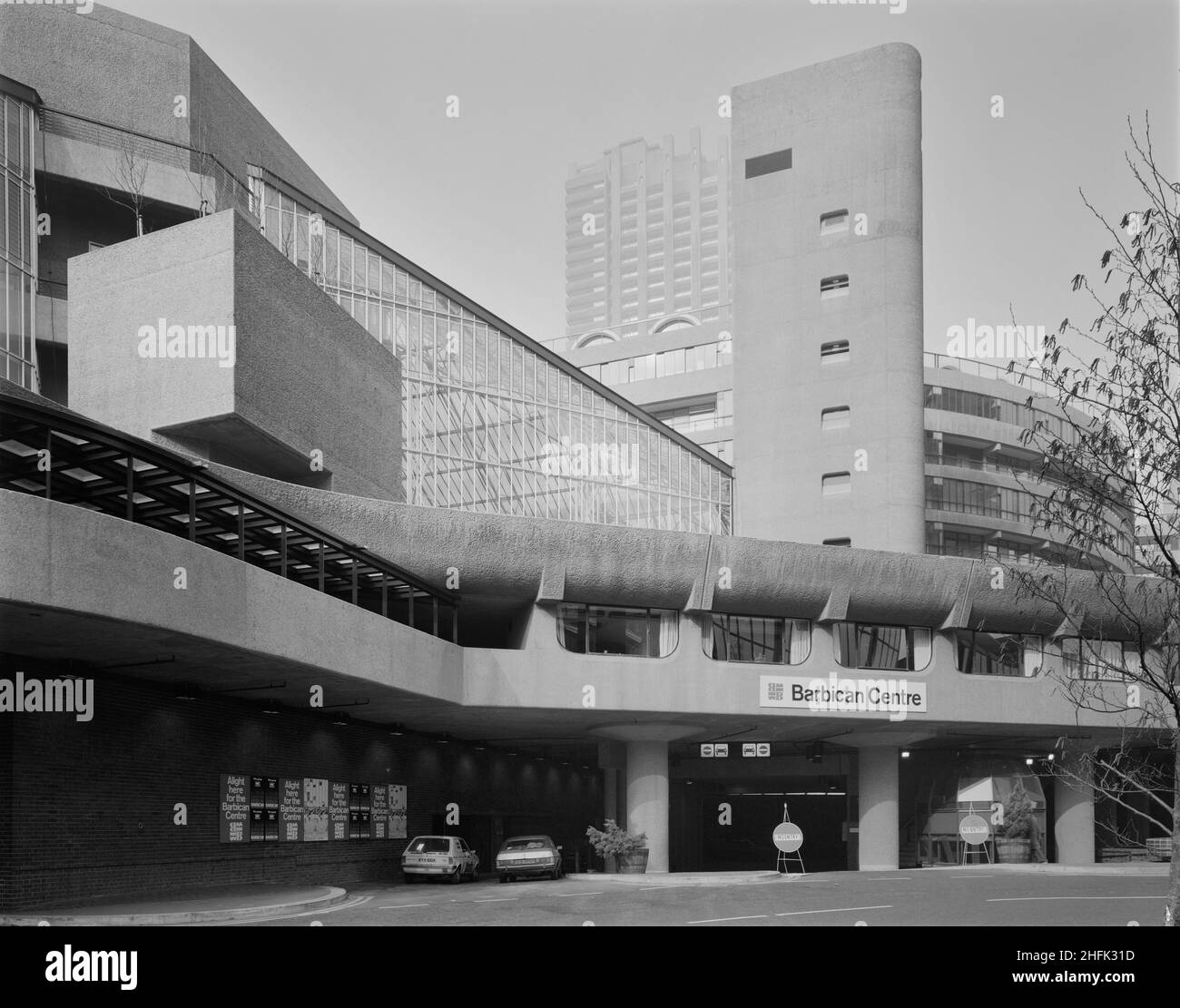 Barbican Centre, Silk Street, City of London, 01/03/1982. An exterior view of the main entrance to the Barbican Arts Centre. John Laing &amp; Son Ltd were responsible for the construction of Phase V of the Barbican development, which included the Barbican Arts Centre and the Guildhall School of Music and Drama. The Barbican Centre is a huge performing arts centre which houses a library, theatre, concert hall, cinemas, conservatory, seminar rooms and more. On Wednesday 3rd March 1982, the Barbican Centre was ceremonially opened by Queen Elizabeth II, who unveiled a commemorative plaque to mark Stock Photo