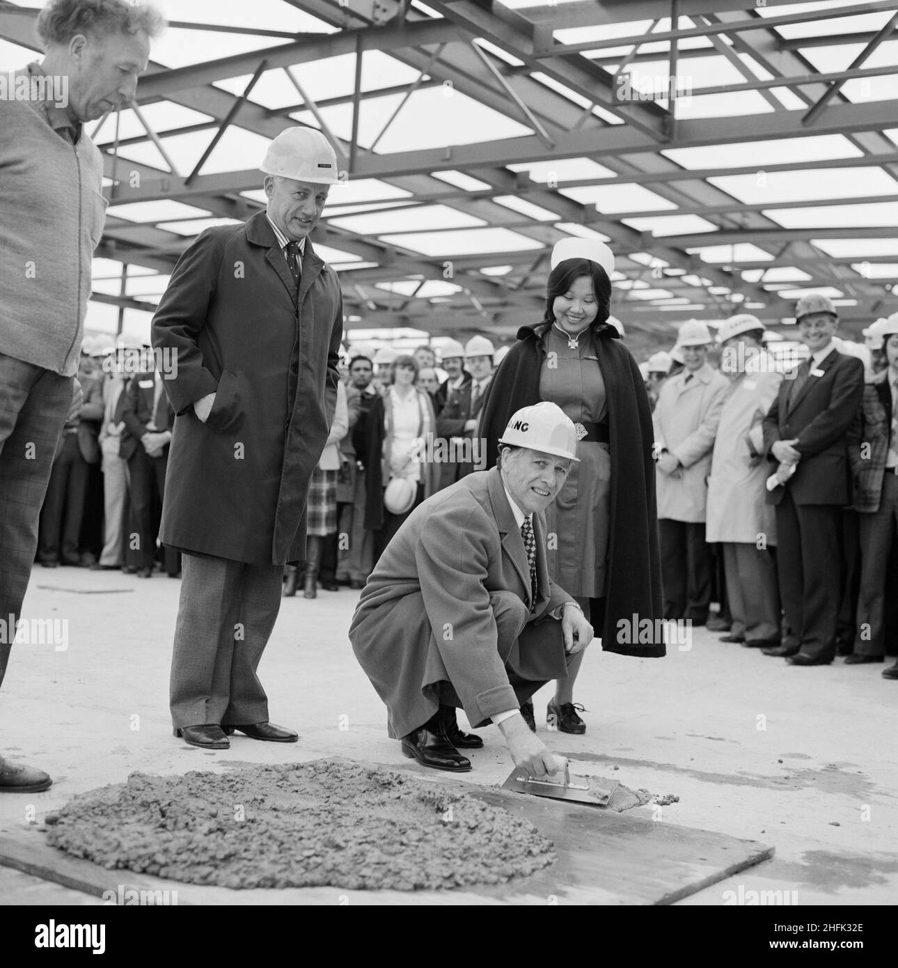Mayday Hospital, London Road, West Thornton, Croydon, London, 01/05/1981. Denis Sweaney, chairman of Croydon Area Health Authority, using a trowel to smooth the final batch of concrete during the topping out of the services block at Mayday Hospital. Laing&#x2019;s Southern Region was awarded the contract for the first phase of a multi-million pound five phase redevelopment project at Mayday Hospital. The contract included a new three storey surgical block with a linked service block, which was to be connected to the main hospital complex by bridge. The topping out of the services block at Mayd Stock Photo