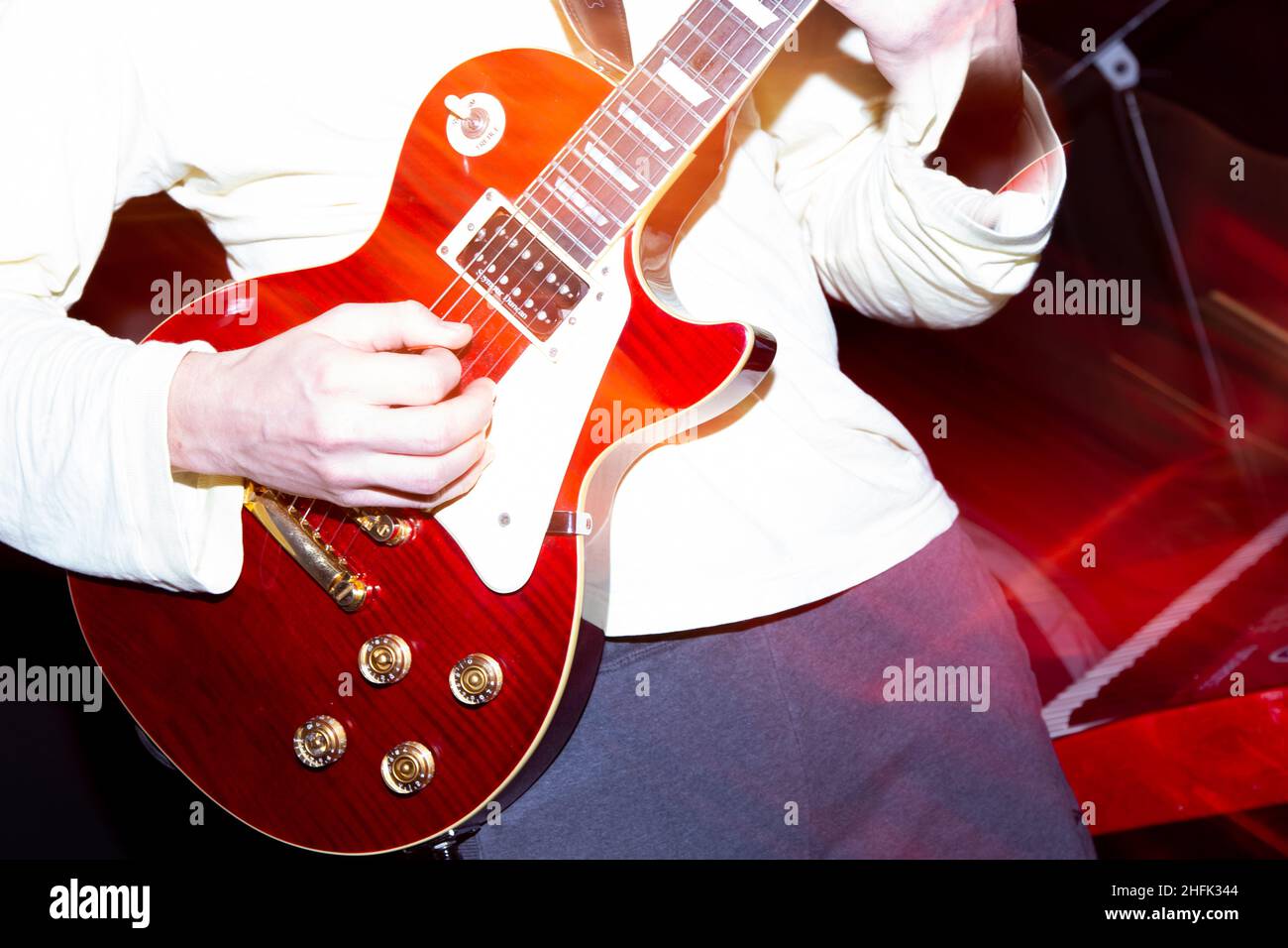 Guitarists playing electric guitars on stage Stock Photo