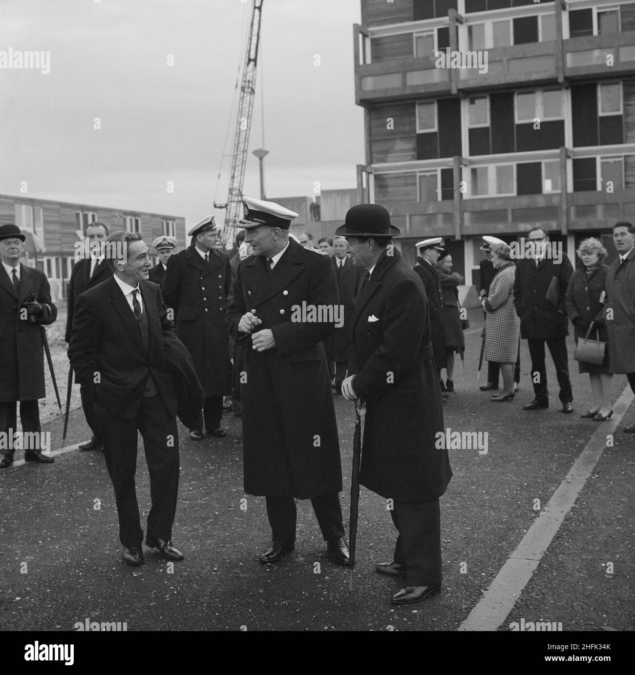 Royal Navy housing, Gosport, Hampshire, 06/12/1966. A group of people including staff from the Royal Navy at the opening of married quarters in Gosport. This Armed Services' housing estate of 1000 12M Jespersen flats and houses was built by the South London Region of Laing's construction company for Royal Navy families. An article and photographs about the event were published in January 1967 in Laing's monthly newsletter 'Team Spirit'. The Commander-in-Chief of Portsmouth, Admiral Sir Frank Hopkins, is seen with two Royal Navy VCs, Jame Joseph Magennis (left) and Thomas William Gould (right) Stock Photo