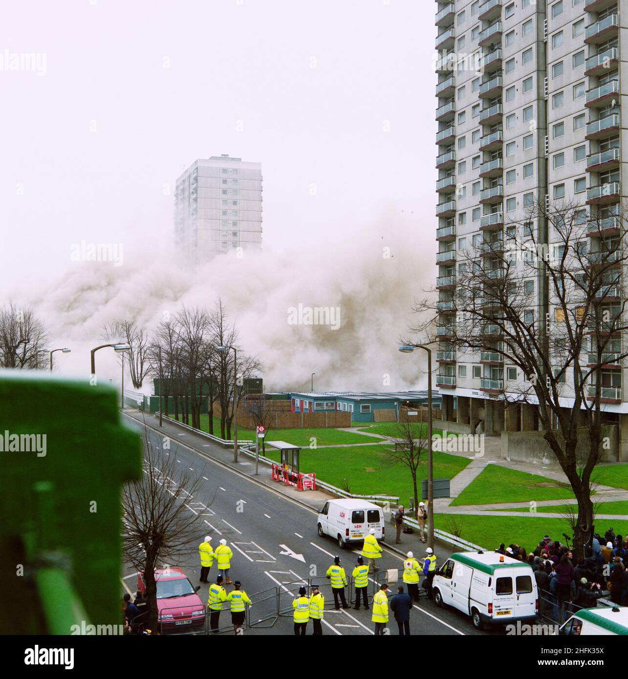 Holly Street Estate, Dalston, Hackney, London, 24/03/1996. A view of tower blocks on the Holly Street Estate, showing a cloud of dust caused by the demolition of Rowan Court at the centre of the group. Laing Homes Special Projects worked in partnership with Hackney Council and a consortium of housing associations to redevelop the estate which had originally been built in the 1970s. The aim of the project was to provide over 1000 new and refurbished homes over a 6 year period, following traditional street patterns and providing gardens for residents. This photograph is part of a batch taken to Stock Photo