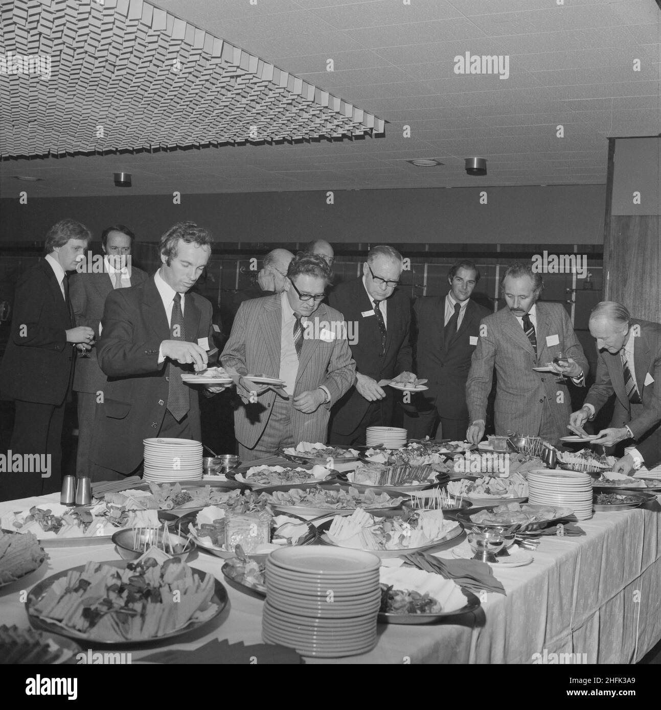 Retirement celebration for W G Cursons in Manchester, 29/09/1976. Guests helping themselves to party food during the retirement celebration for W G Cursons in Manchester.  W G Cursons was a Laing Regional Director for the north-west. He retired in 1976 with 45 years of service to the Company. Stock Photo