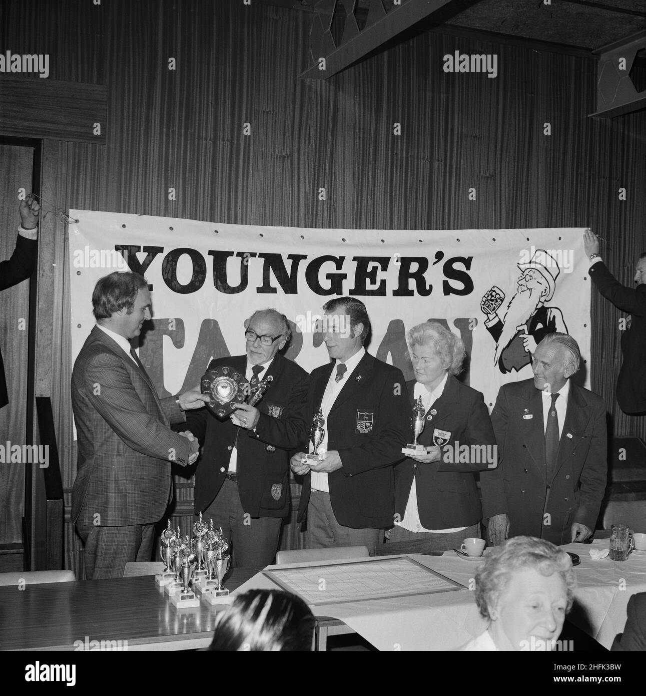 Laing Sports Ground, Rowley Lane, Elstree, Barnet, London, 23/09/1979. The winning team of a Mixed Triples Bowls Tournament being presented with a shield by Terry Eves, representing event sponsors Scottish and Newcastle Breweries, with club treasurer Ron Homewood on the right. A similar image was published in November 1979 in Laing's monthly Team Spirit newsletter. From left to right: Terry Eves of Scottish and Newcastle Breweries; Laing winning triples: Bob Loudon, Jean Bowden and John Cannon; and Ron Homewood. Stock Photo