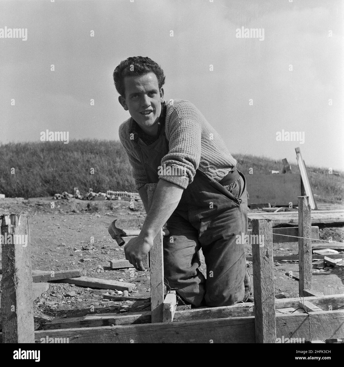 County High School, Gedling Road, Arnold, Gedling, Nottinghamshire, 25/09/1958. M Williamson, an apprentice joiner, working on the construction of Arnold County High School. M Williamson was featured as Apprentice of the Month in the November 1958 issue of Team Spirit, the Laing company newsletter. Born in Doncaster, the son of a miner, he joined the company in 1953, preferring an outdoor job to following his father into the pit. Williamson worked on a number of projects in Richmond, Yorkshire, and Birmingham and would complete his apprenticeship in May 1959. Stock Photo