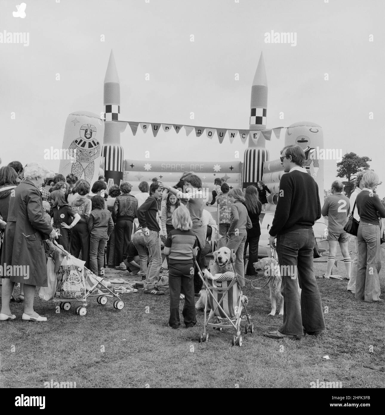 Laing Sports Ground, Rowley Lane, Elstree, Barnet, London, 16/06/1979. A crowd of people gathered around a bouncy castle at the annual Laing Gala Day. Stock Photo