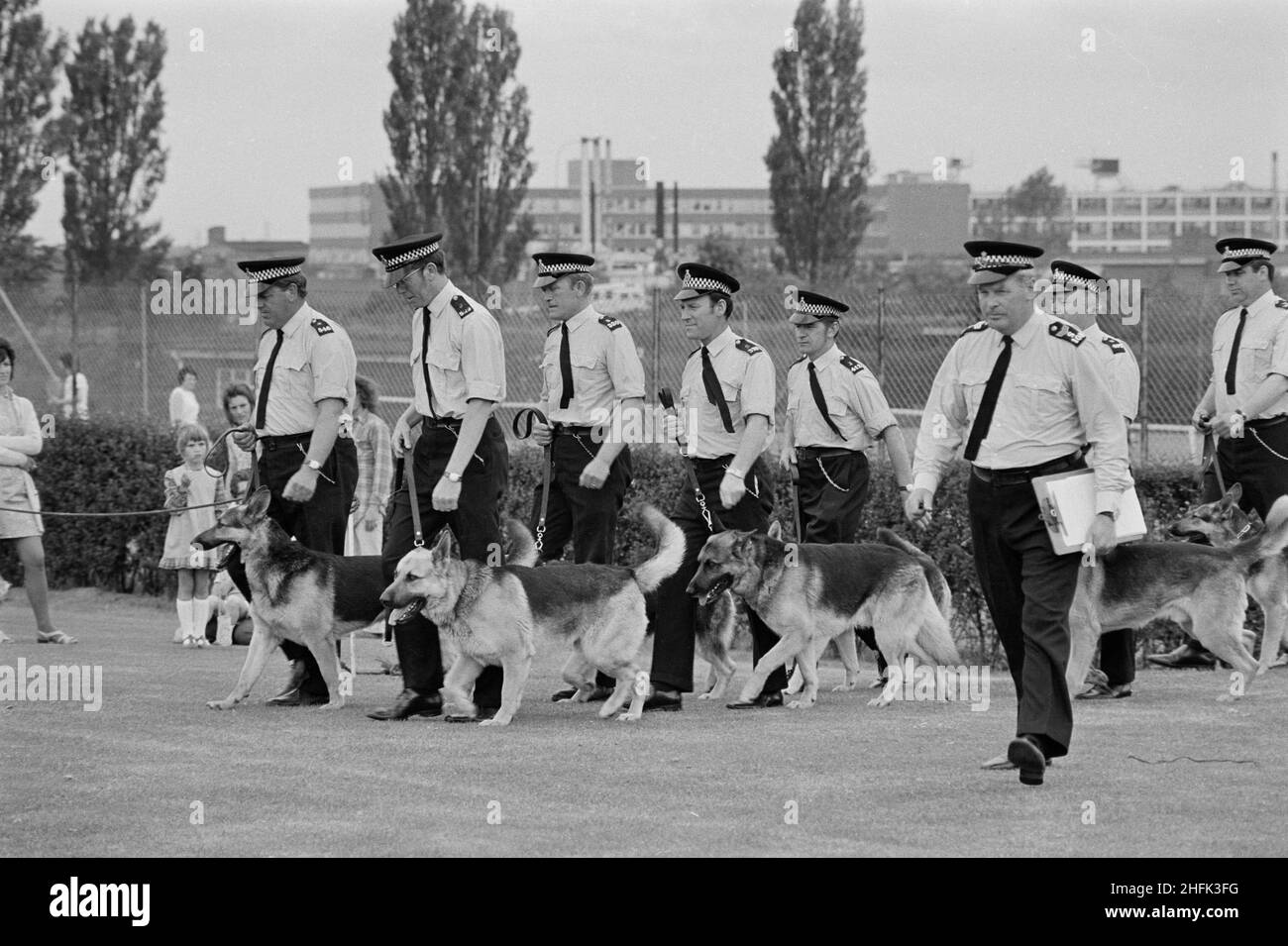 Laing Sports Ground, Rowley Lane, Elstree, Barnet, London, 09/06/1973. Police dog handlers leading their dogs during a demonstration at the annual Gala Day held at the Laing Sports Ground at Elstree. The annual Gala Day was held at the Laing Sports Ground on 9th June 1973. Attractions included model aircraft, the Royal British Legion band, children's races, and sports. Demonstrations of obedience and mock arrests were given by police dogs and handlers. In the evening there was dancing and bingo in the Club House, and 'beer and beat' in the marquee. Over 2,000 people attended the gala, and over Stock Photo