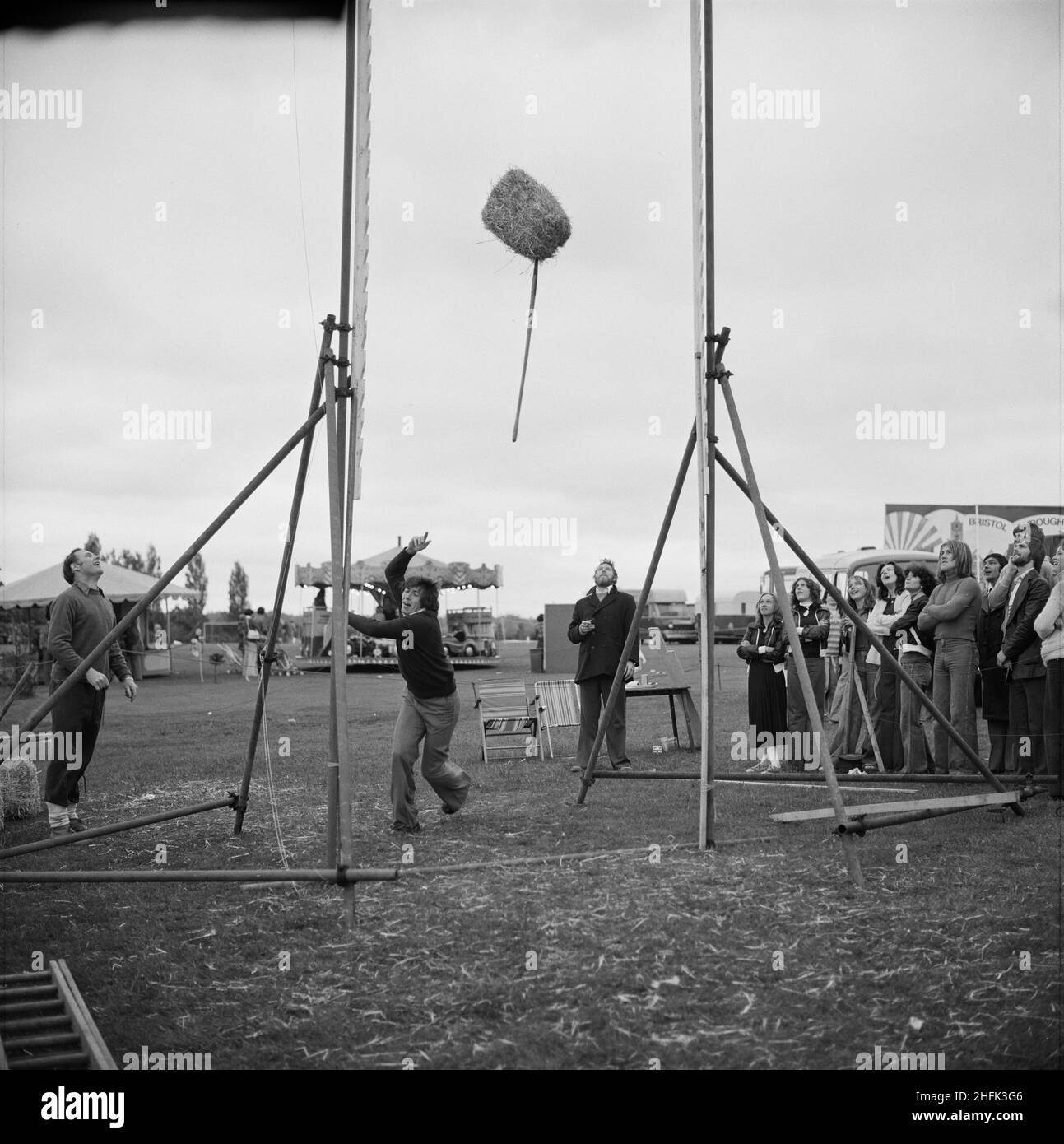 Laing Sports Ground, Rowley Lane, Elstree, Barnet, London, 18/06/1977. A man attempting the 'Hay Toss' at the annual Gala Day, held at the Laing Sports Ground in Elstree. The 'Hay Toss' was run by Laing's Flying Section, the aim was to launch a bale of hay over a high bar using a pitchfork. Stock Photo