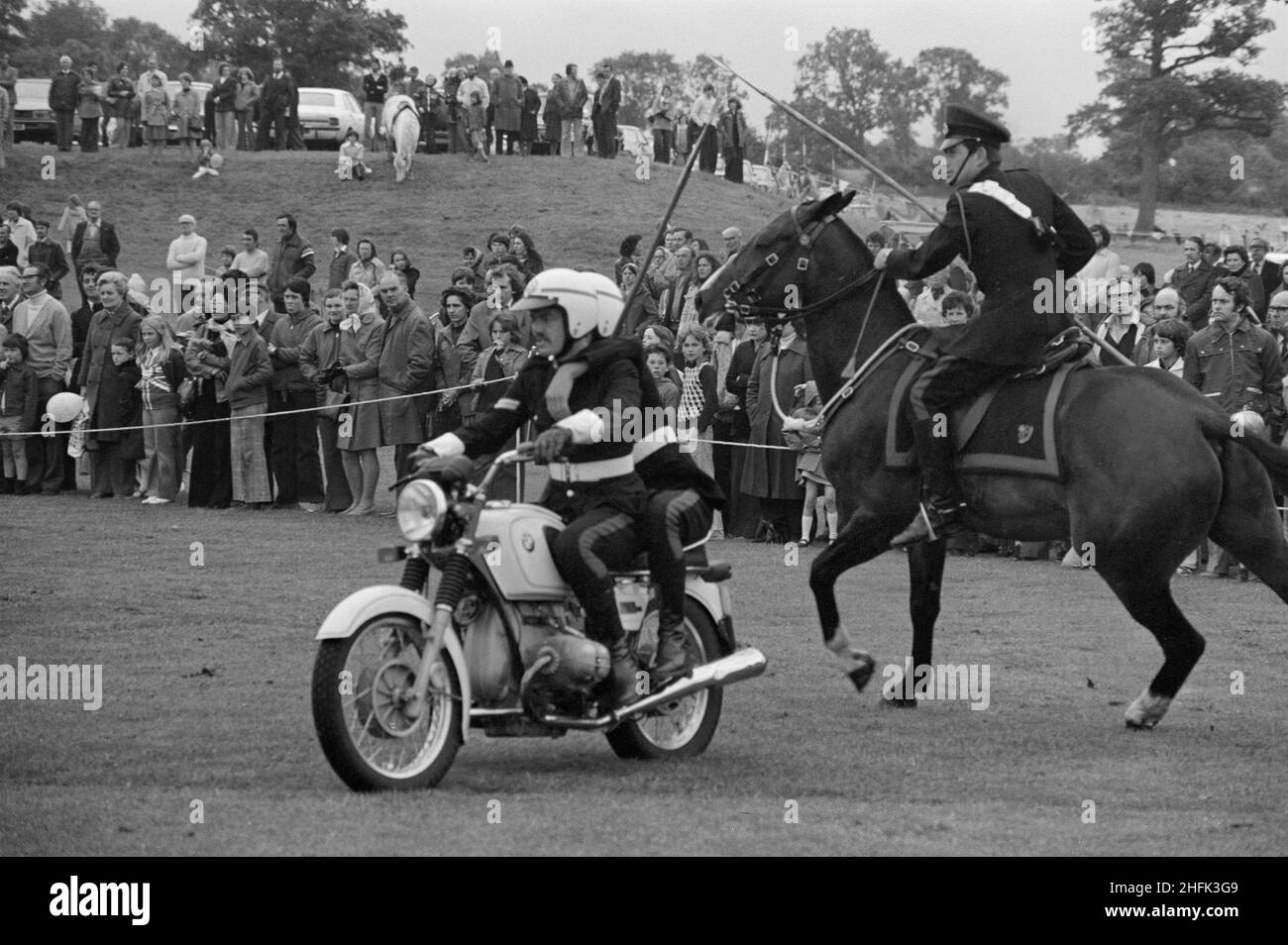 Laing Sports Ground, Rowley Lane, Elstree, Barnet, London, 18/06/1977. A motorbike and horse riding display by the Mounted Division of the Royal Military Police, during the Jubilee Gala Day held at the Laing Sports Ground. Stock Photo