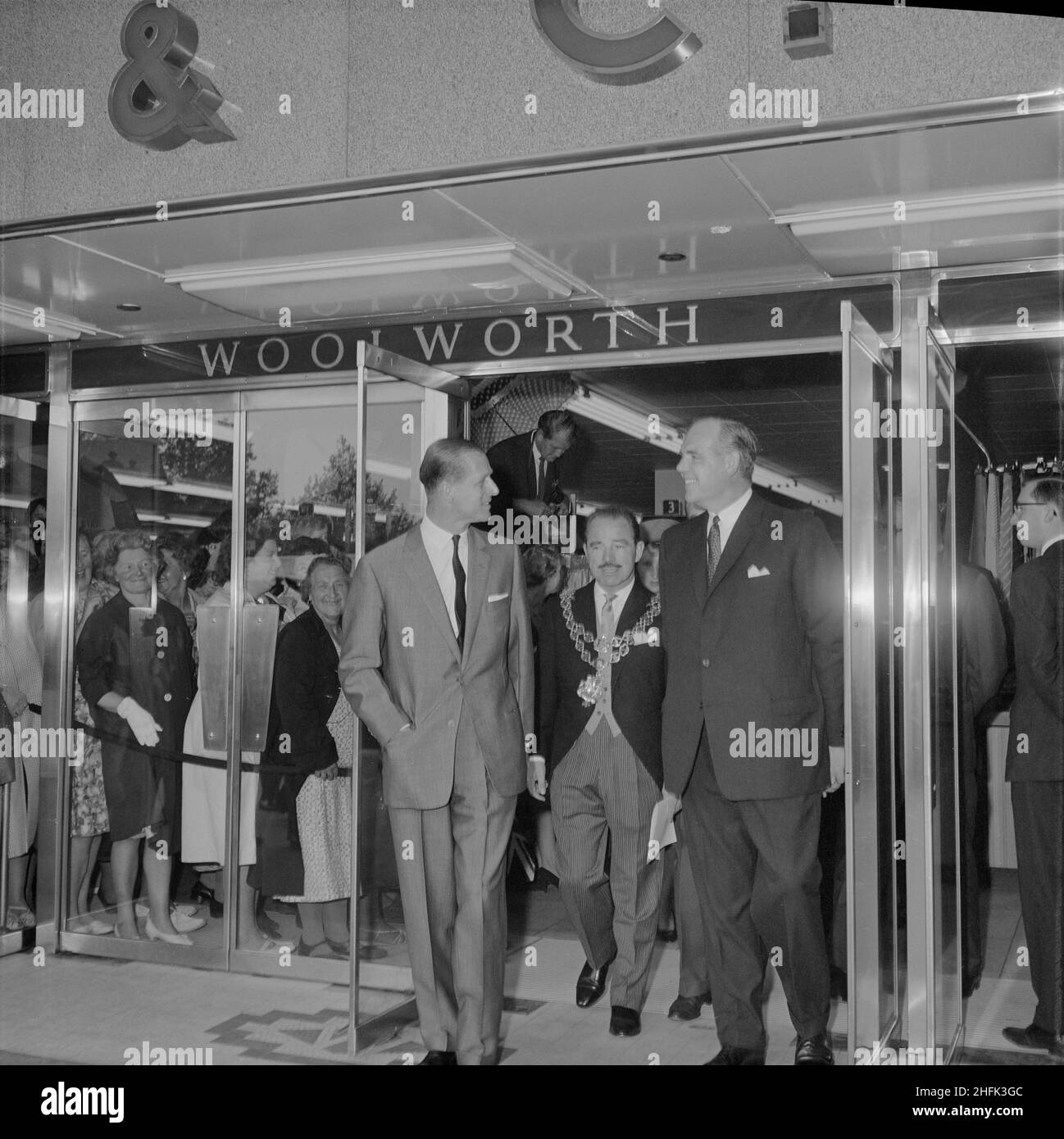Bull Ring Centre, Birmingham, 29/05/1964. HRH Prince Philip exiting the new Woolworth's store at the Bull Ring Centre on the day of the opening ceremony. On 29th May 1964, His Royal Highness Prince Philip, Duke of Edinburgh, opened the Bull Ring Centre. The Duke toured the site, meeting various people along the way and unveiling a commemorative plaque in the Centre Court. A formal lunch was then held in his honour at the Mecca Banqueting Hall; part of the new Bull Ring development. Approximately 400 guests attended including the Lord Mayor of Birmingham; Alderman F Price (seen in this image), Stock Photo