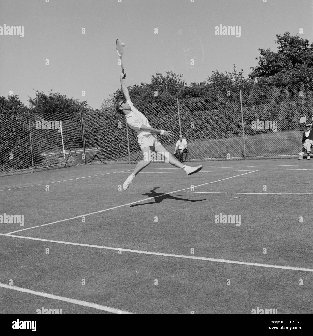 Laing Sports Ground, Rowley Lane, Elstree, Barnet, London, 11/06/1970. A man jumping to hit a tennis ball during a match at the Finals Day of the Laing Tennis Section held at the Laing Sports Ground at Elstree. The 1970 Finals Day of the Laing Sports Club Tennis Section was held on 11th June. The trophies were presented by Lillian Martin. Stock Photo