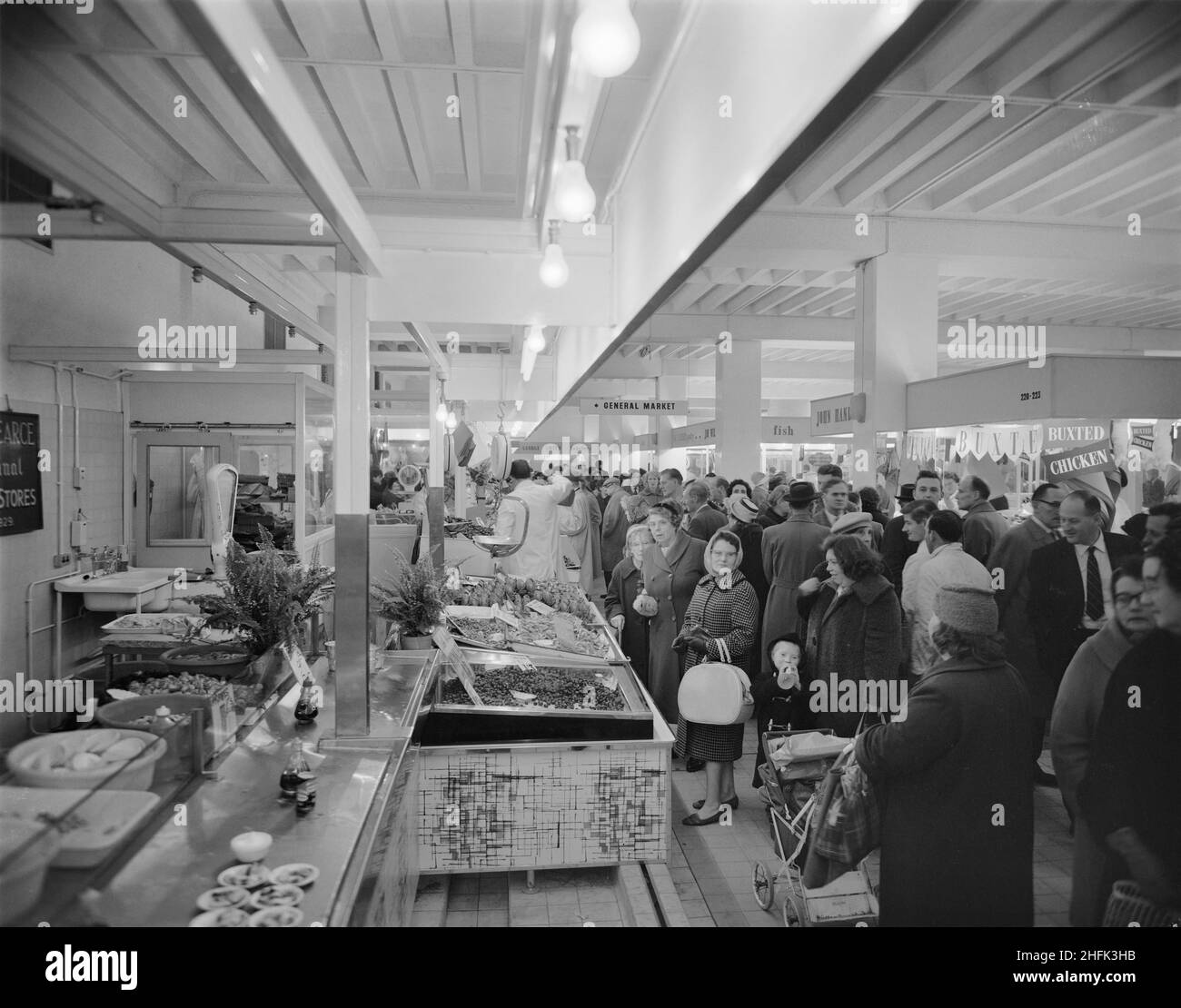 Bull Ring Centre, Birmingham, 14/11/1963. The fish market at the Bull Ring Centre bustling with shoppers on the day it opened to the public. On 14th November 1963, the retail market at the Bull Ring development was opened by the Lord Mayor of Birmingham, Alderman Dr. Louis Glass, JP. The new retail market replaced the old Market Hall building, which was originally built in 1835 but had suffered serious damage from an air strike in the Second World War. The general section of the new market housed 154 stalls, with a further 42 in the separate fish and poultry section. Stock Photo
