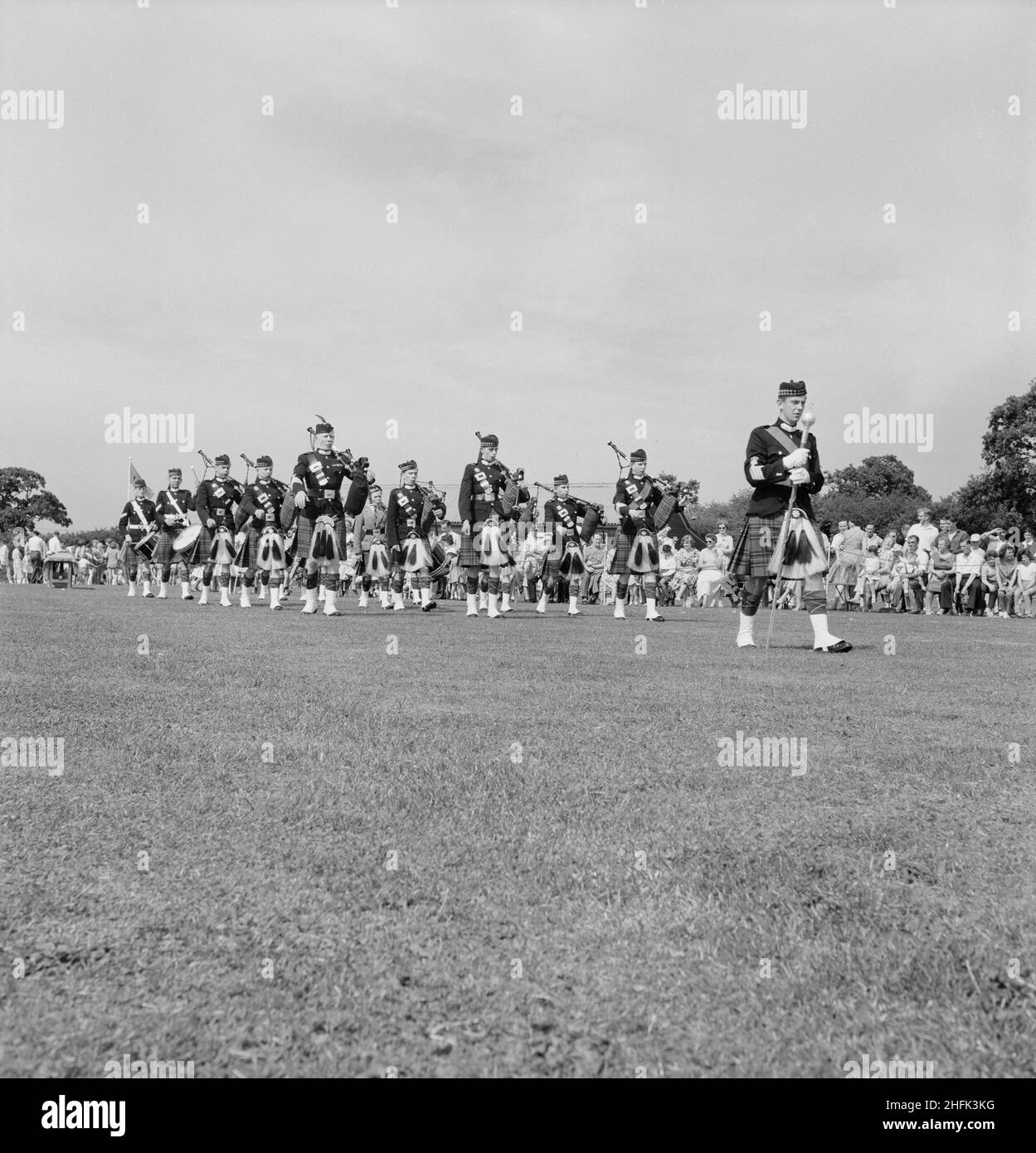 Laing Sports Ground, Rowley Lane, Elstree, Barnet, London, 18/06/1960. A marching Scottish pipe band performing during a Laing sports day at Elstree. Stock Photo
