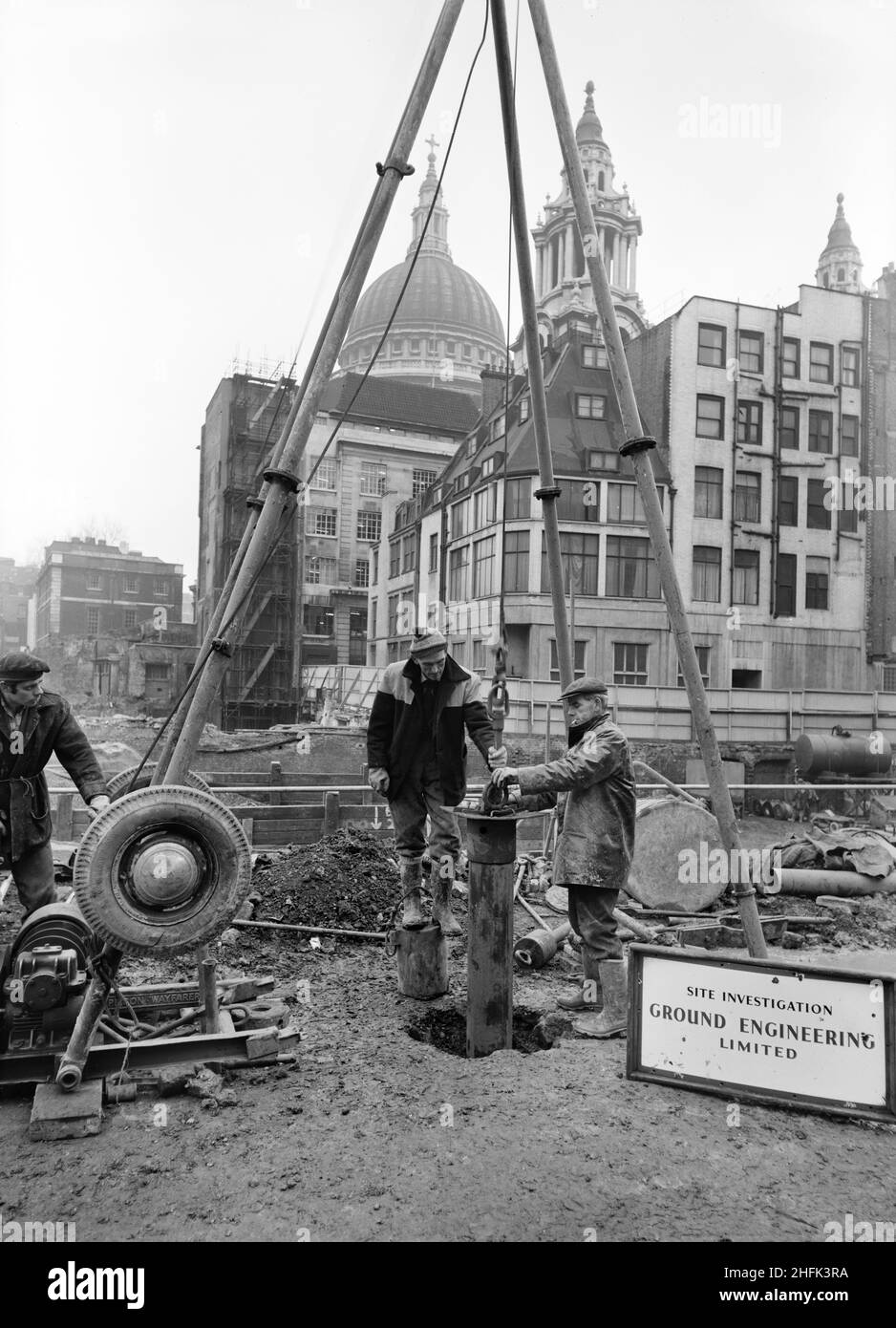 Paternoster Square, City of London, 01/03/1962. A team from Ground Engineering Ltd carrying out a site survey with a soft drilling rig during construction of the Paternoster development. Work on the Paternoster development was carried out in a joint venture by John Laing Construction Limited, Trollope and Colls Limited, and George Wimpey and Company Limited. The scheme involved the redevelopment of a seven acre site on the north side of St Paul&#x2019;s Cathedral. The site had been almost entirely devastated during an incendiary raid in December 1940. The development consisted of a series of o Stock Photo