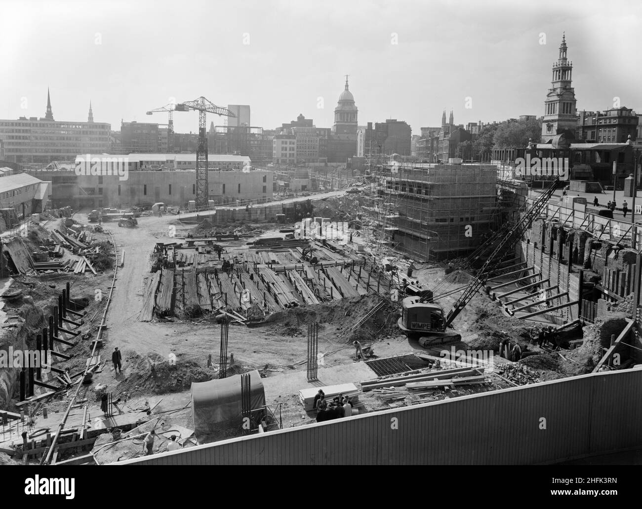 Paternoster Square, City of London, 04/06/1962. Looking west during the construction of the Paternoster development, showing the Old Bailey in the background and Christchurch Greyfriars on the right. Work on the Paternoster development was carried out in a joint venture by John Laing Construction Limited, Trollope and Colls Limited, and George Wimpey and Company Limited. The scheme involved the redevelopment of a seven acre site on the north side of St Paul&#x2019;s Cathedral. The site had been almost entirely devastated during an incendiary raid in December 1940. The development consisted of Stock Photo