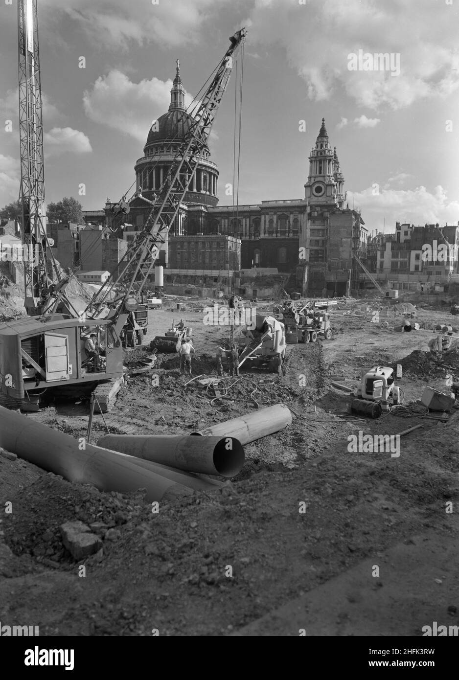 Paternoster Square, City of London, 15/09/1961. A McKinney Foundations crane and pile driver at work during the construction of the Paternoster development, with St Paul's Cathedral in the background. Work on the Paternoster development was carried out in a joint venture by John Laing Construction Limited, Trollope and Colls Limited, and George Wimpey and Company Limited. The scheme involved the redevelopment of a seven acre site on the north side of St Paul&#x2019;s Cathedral. The site had been almost entirely devastated during an incendiary raid in December 1940. The development consisted of Stock Photo