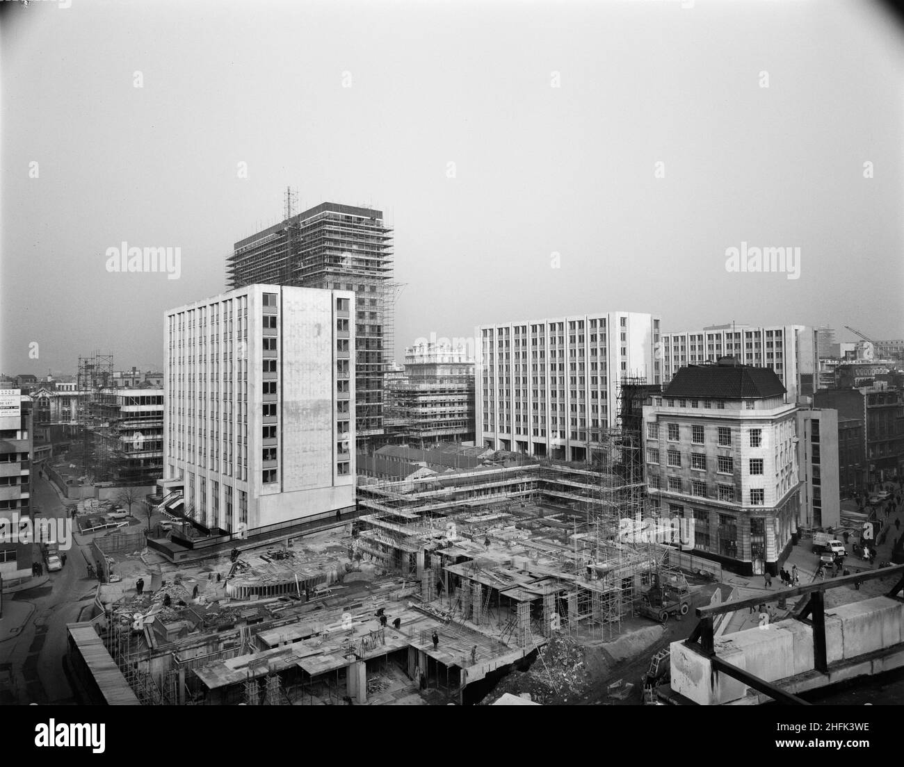 Paternoster Square, City of London, 16/01/1964. Looking north-east across the Paternoster development during its construction, showing completed blocks and some under construction including Sudbury House. Work on the Paternoster development was carried out in a joint venture by John Laing Construction Limited, Trollope and Colls Limited, and George Wimpey and Company Limited. The scheme involved the redevelopment of a seven acre site on the north side of St Paul&#x2019;s Cathedral. The site had been almost entirely devastated during an incendiary raid in December 1940. The development consiste Stock Photo