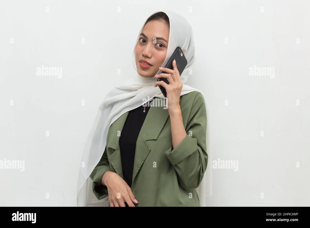 happy young asian muslim woman using mobile phone Stock Photo - Alamy