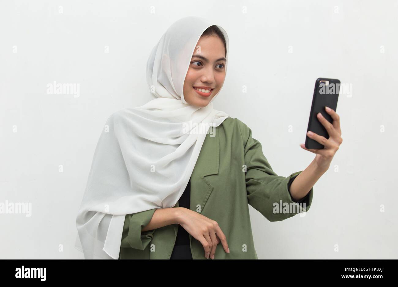 happy young asian muslim woman using mobile phone Stock Photo - Alamy