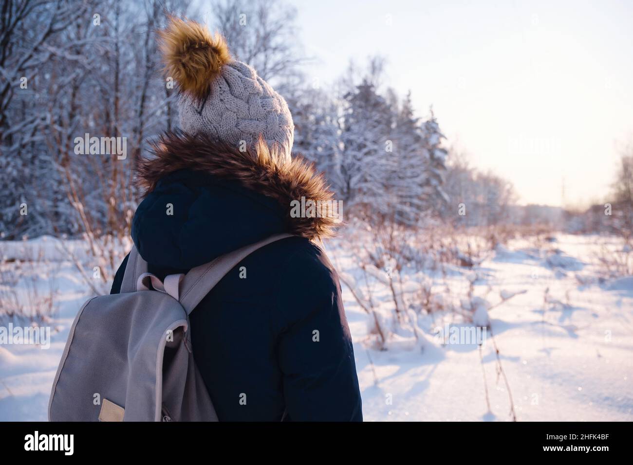 Happy Asian woman walking in winter snow forest. Cold weather hat and ...