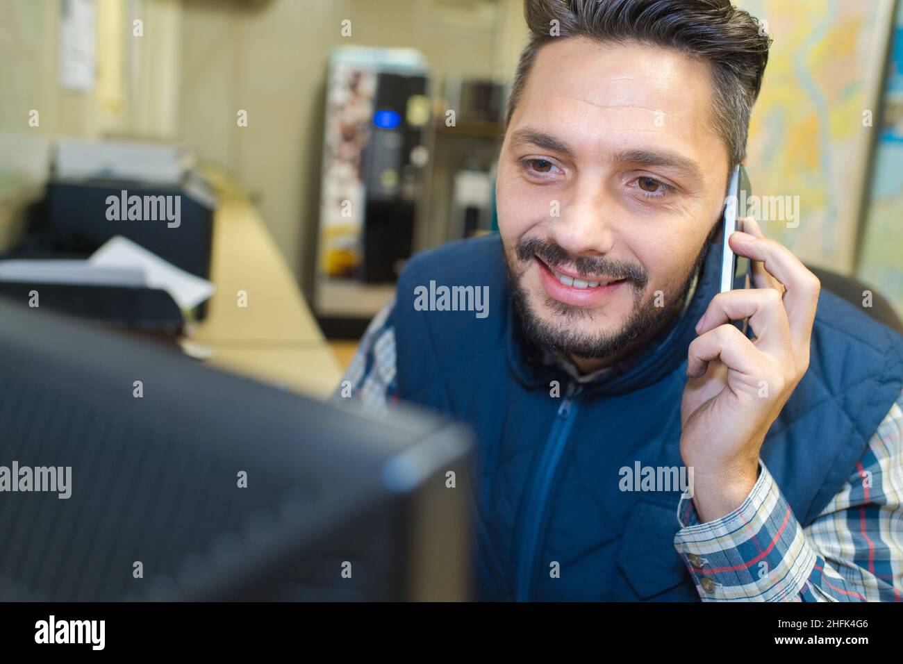 technician talking on mobile phone while working in server room Stock ...