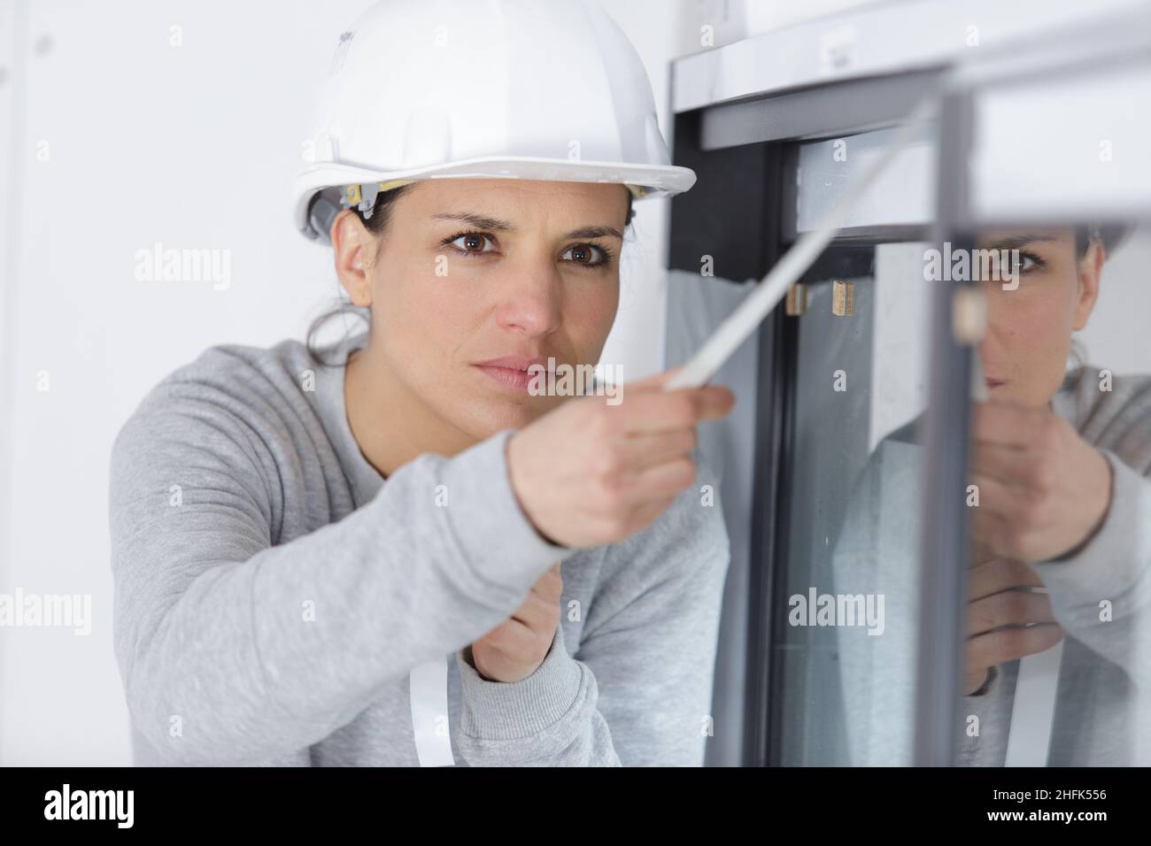 fixing the window blinds Stock Photo Alamy