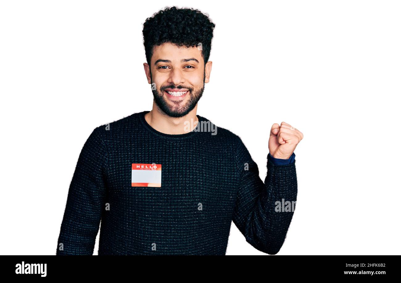 Young arab man with beard wearing hello my name is sticker ...