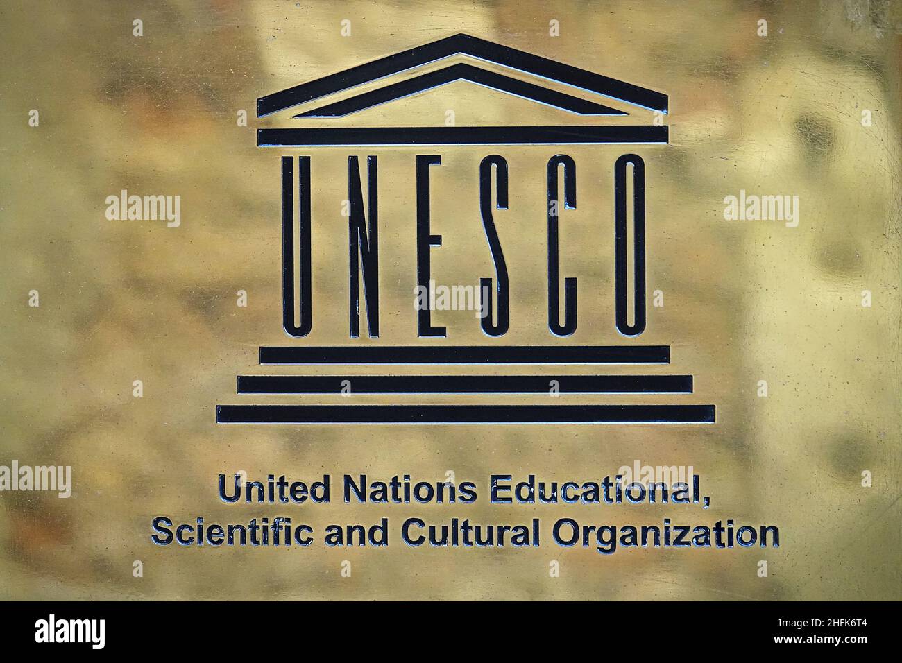 UNESCO logo on brass plate. UNESCO, the United Nations Educational, Scientific and Cultural Organisation. Paris, France - January 2022 Stock Photo