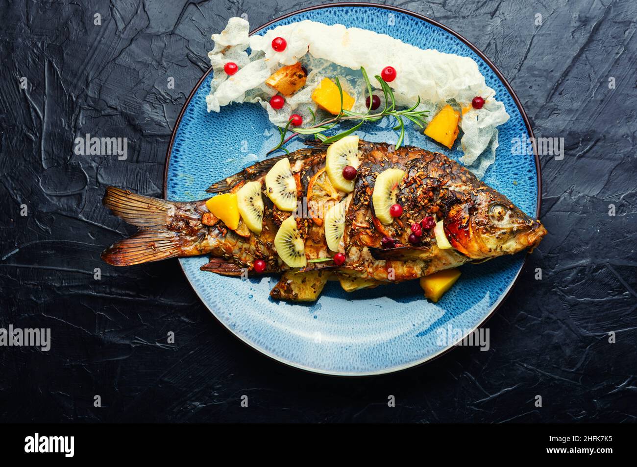 Baked fish carp with fruits, berries and spices. Healthy eating Stock