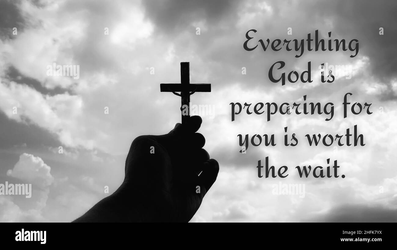 Christian inspirational quote - Everything God is preparing for you is worth the wait. With hand holding a cross and sky background. Stock Photo