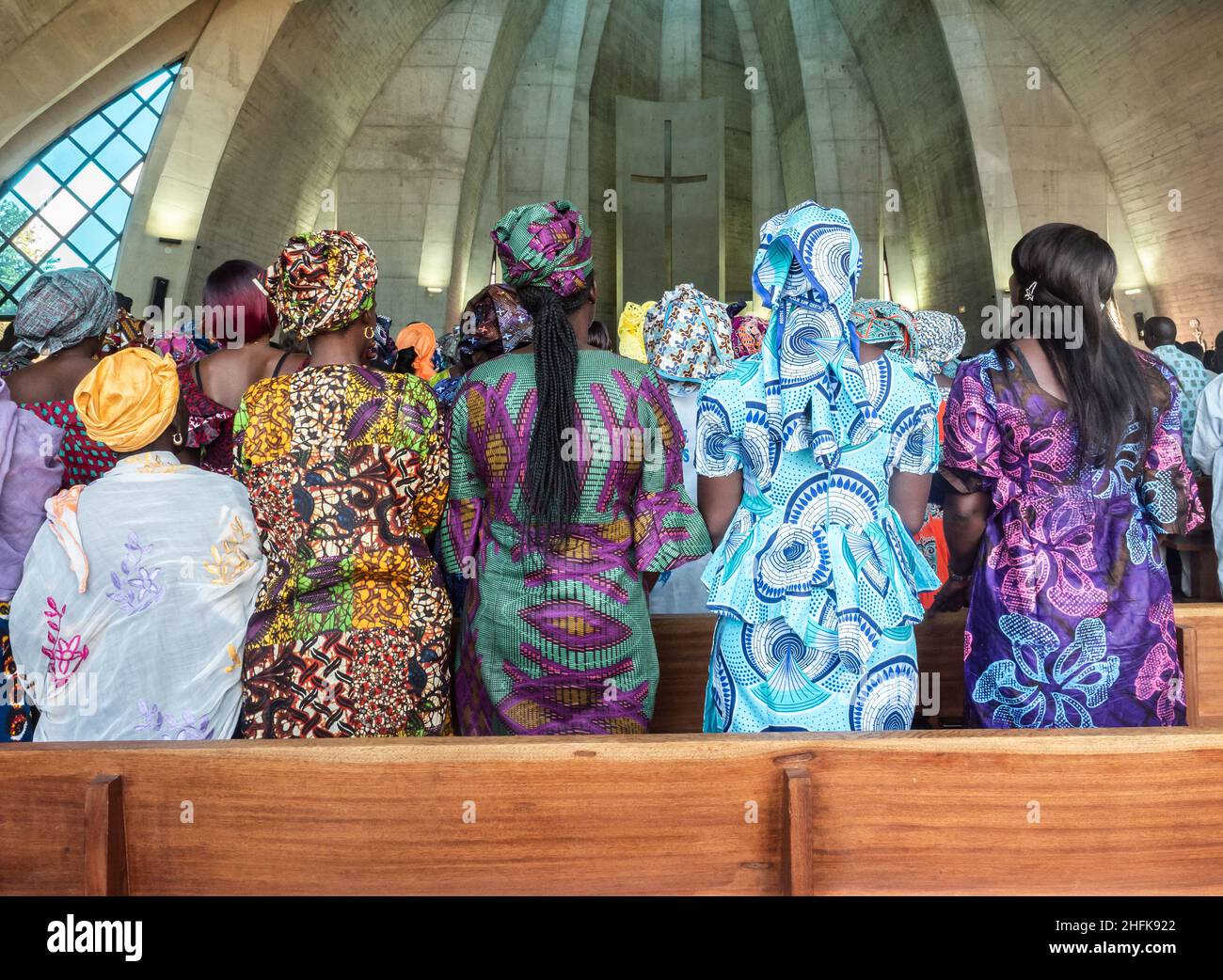 Senegal, Africa - January 2019: African people in colorful clothes (boubou) during a mass at a Catholic church in West Africa Stock Photo
