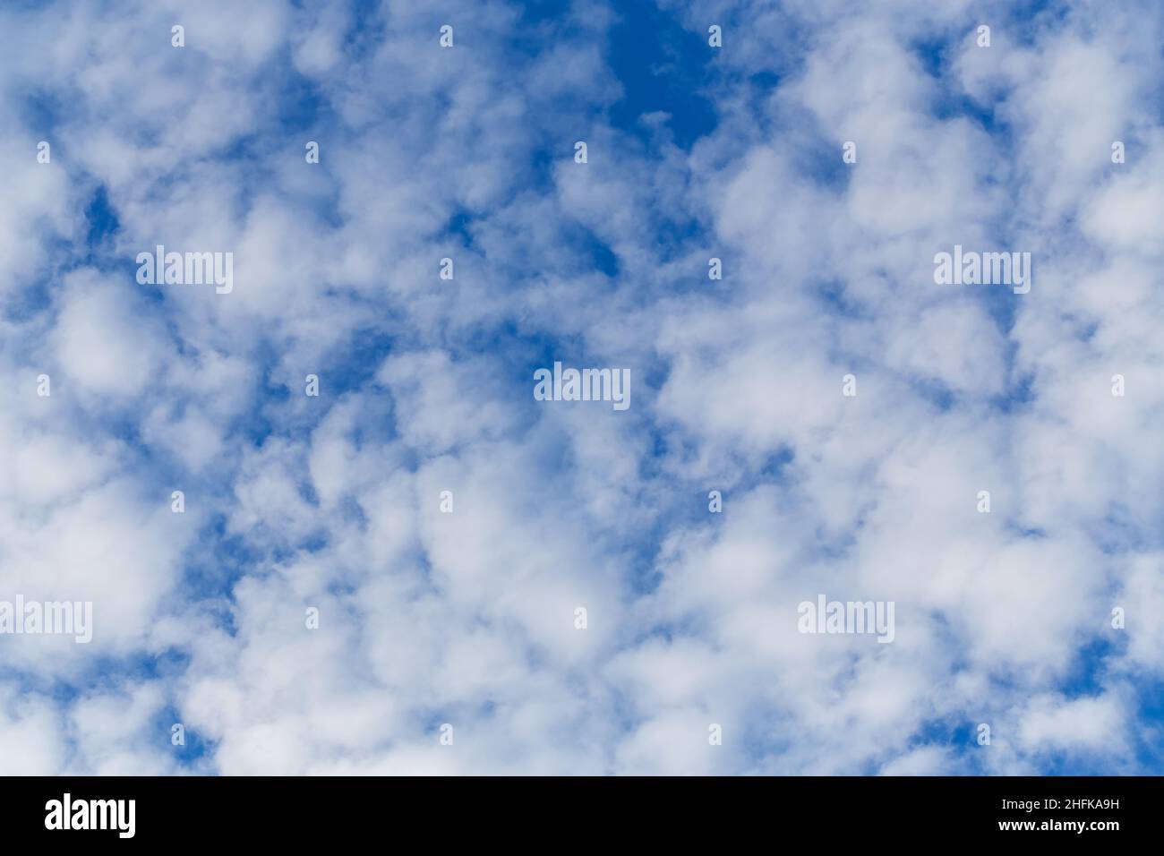 White fluffy clouds on the bright blue sky background Stock Photo - Alamy