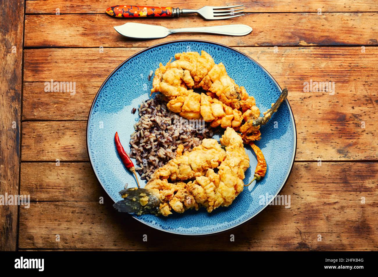 Fried sea bass fish with rice on rice paper. Roasted seafood Stock Photo Alamy