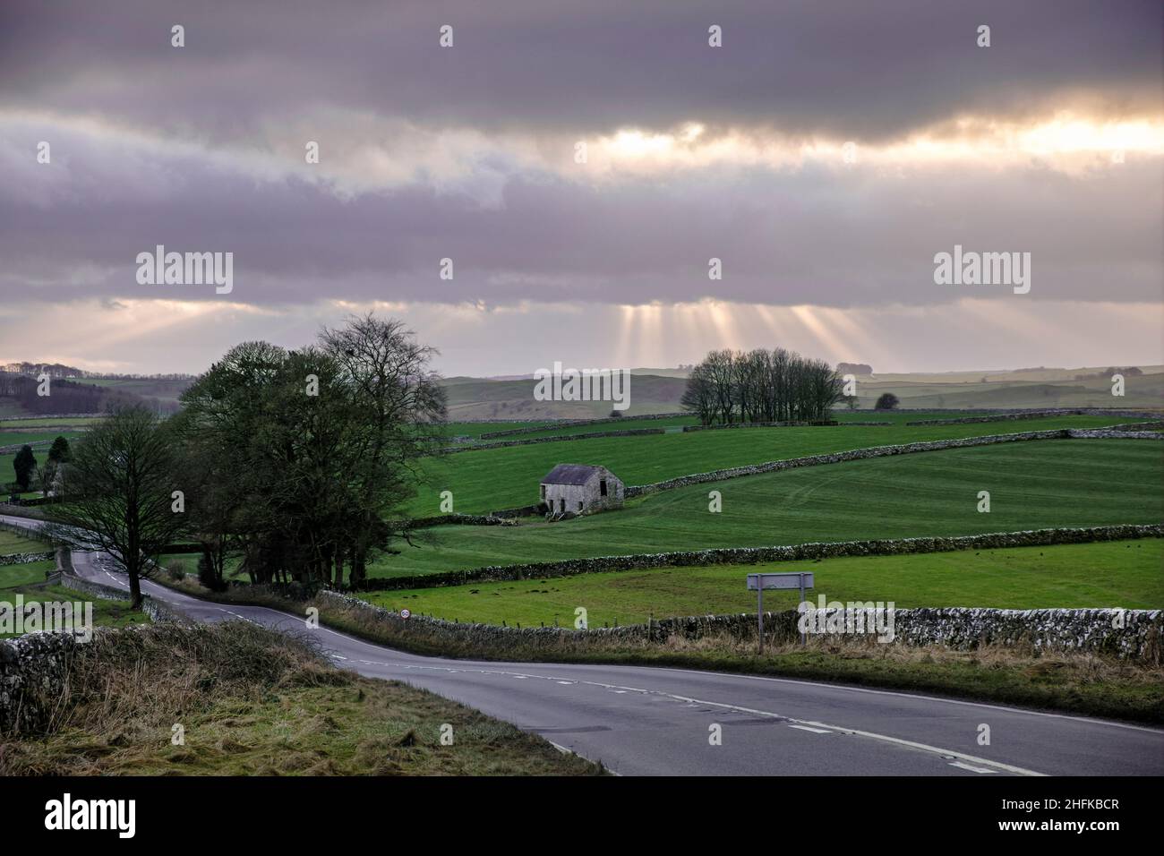 The road through the Peak District heading towards Ashbourne, near Alsop Station, Derbyshire, England Stock Photo