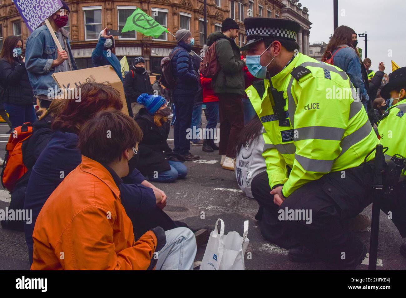 London, UK 15th January 2022. A police officer talks to Kill The Bill protesters blocking the streets around the Strand. Thousands of people marched through central London in protest against the Police, Crime, Sentencing and Courts Bill, which will make many types of protest illegal. Stock Photo