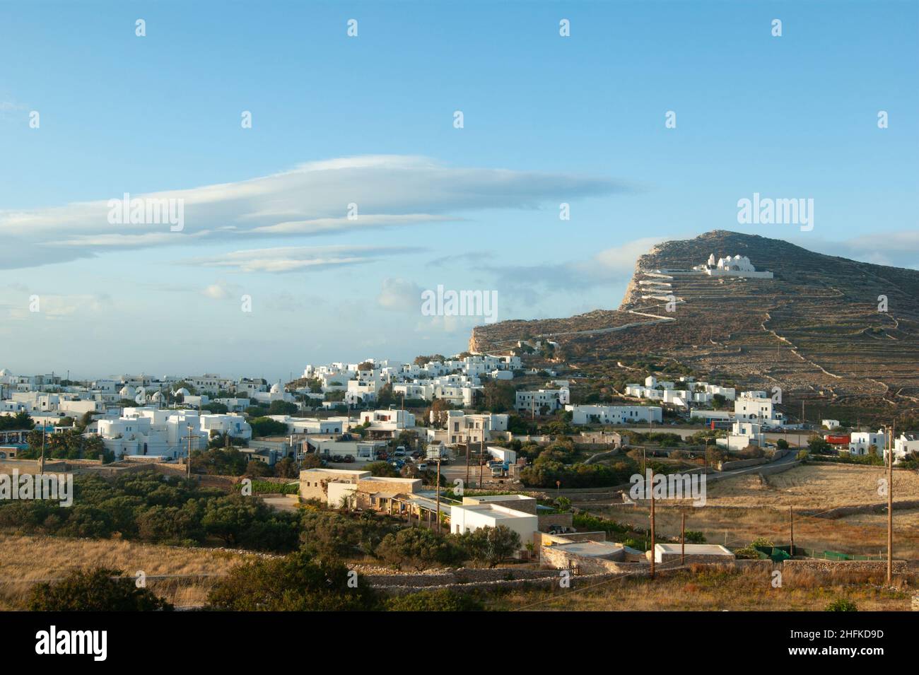 Beautiful Folegandros island, Greece. View of the charming old town with the historic church of the Panagia high on a hillside.  Landscape aspect view Stock Photo